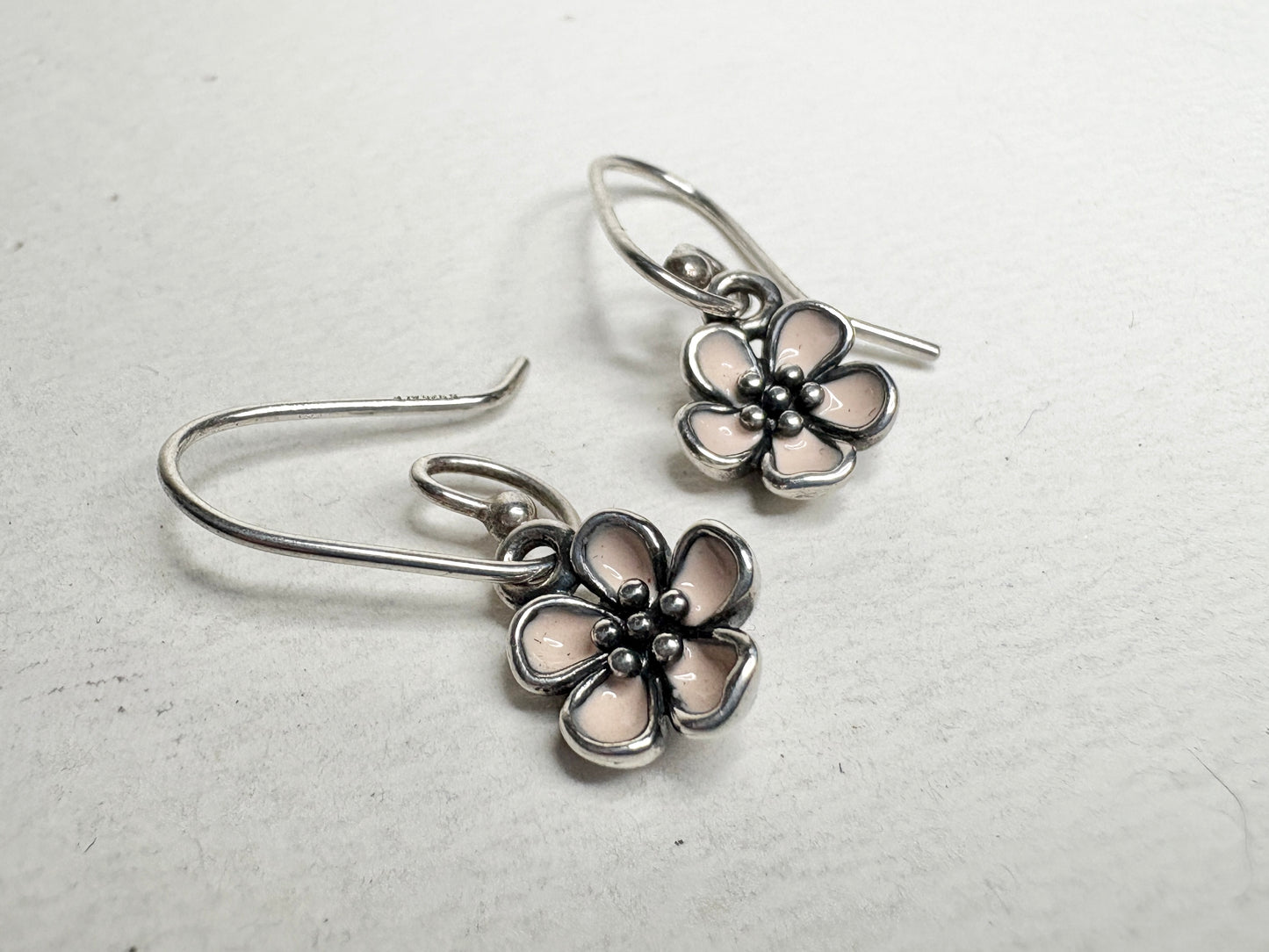 Pandora sterling silver dangle earrings with pink enamel cherry blossom charms.