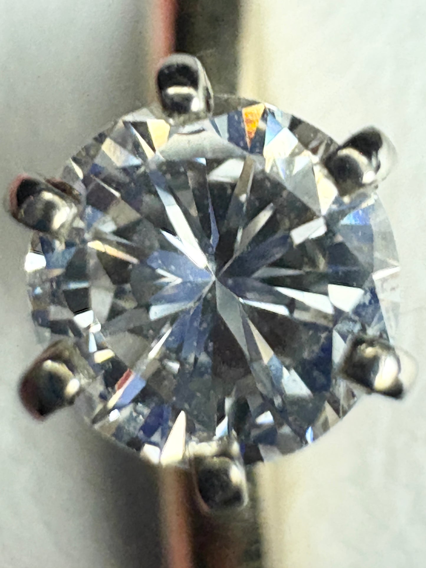 A round brilliant cut diamond solitaire engagement ring with six prongs.