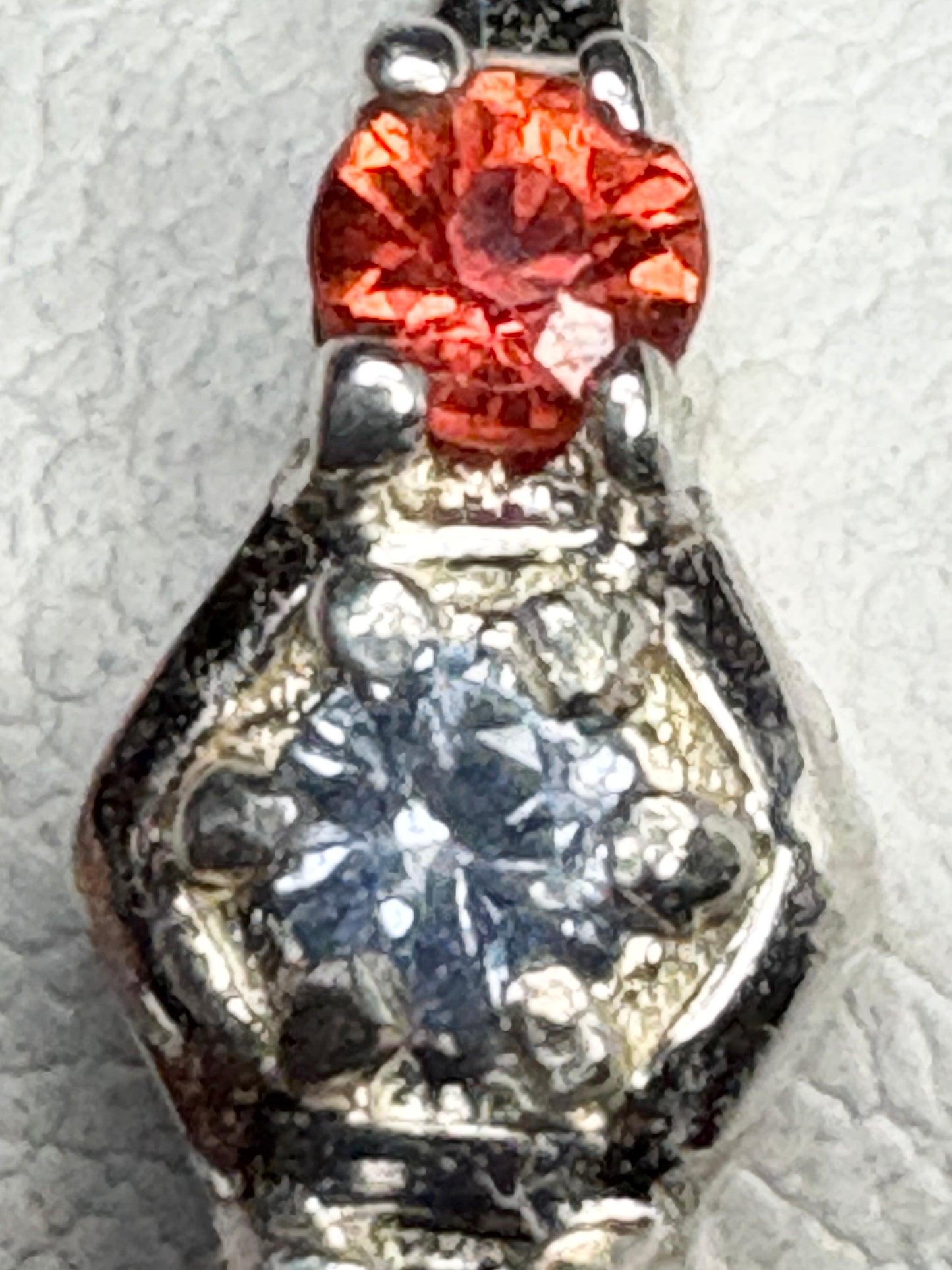 Sterling silver ring with a red gemstone and honeycomb pattern.