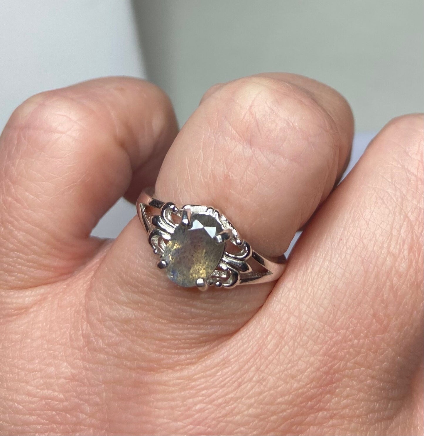 Sterling silver ring with oval labradorite and fleur de lis accents.