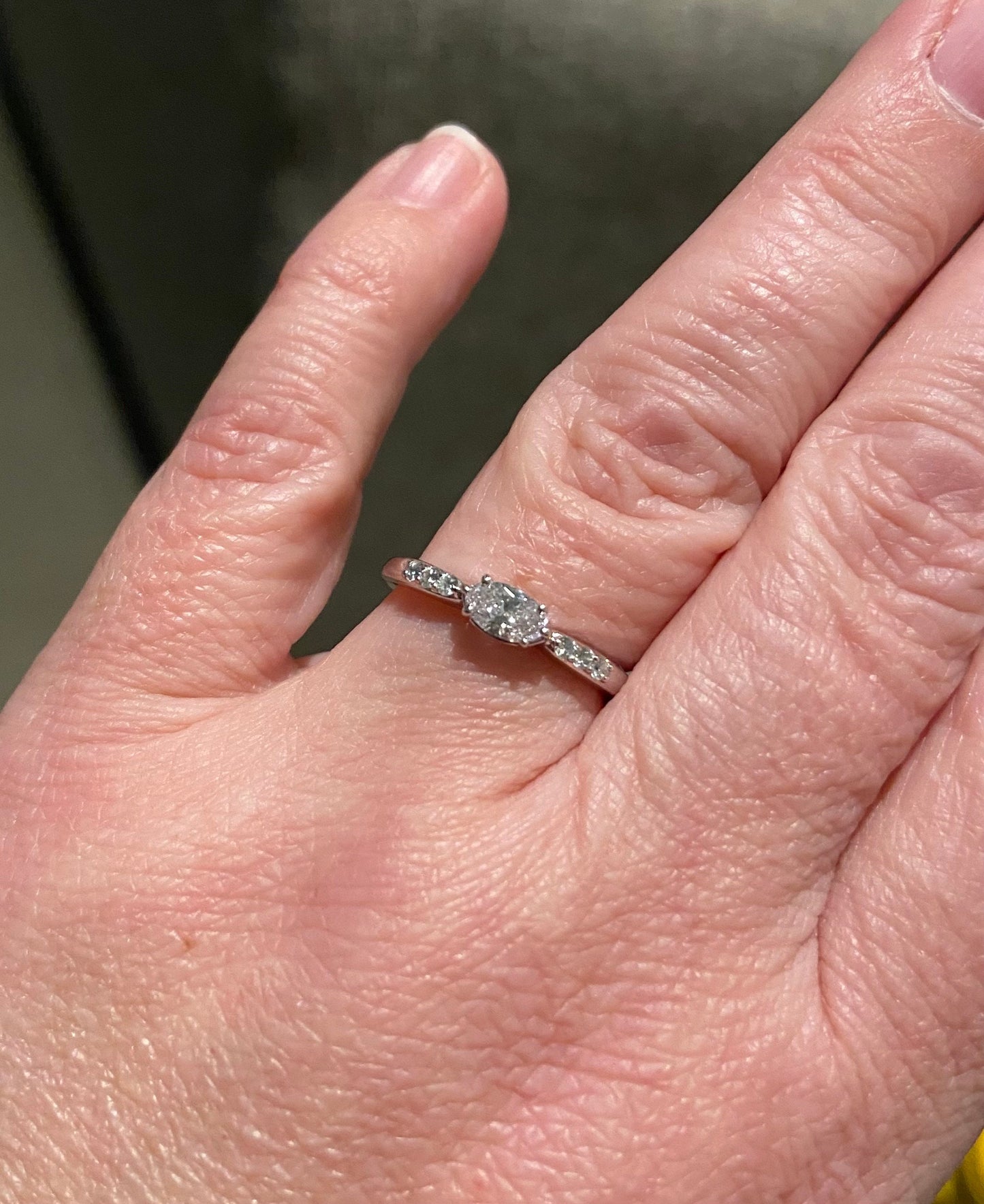 A 14k white gold band ring with a marquise-cut pink diamond and accent diamonds.