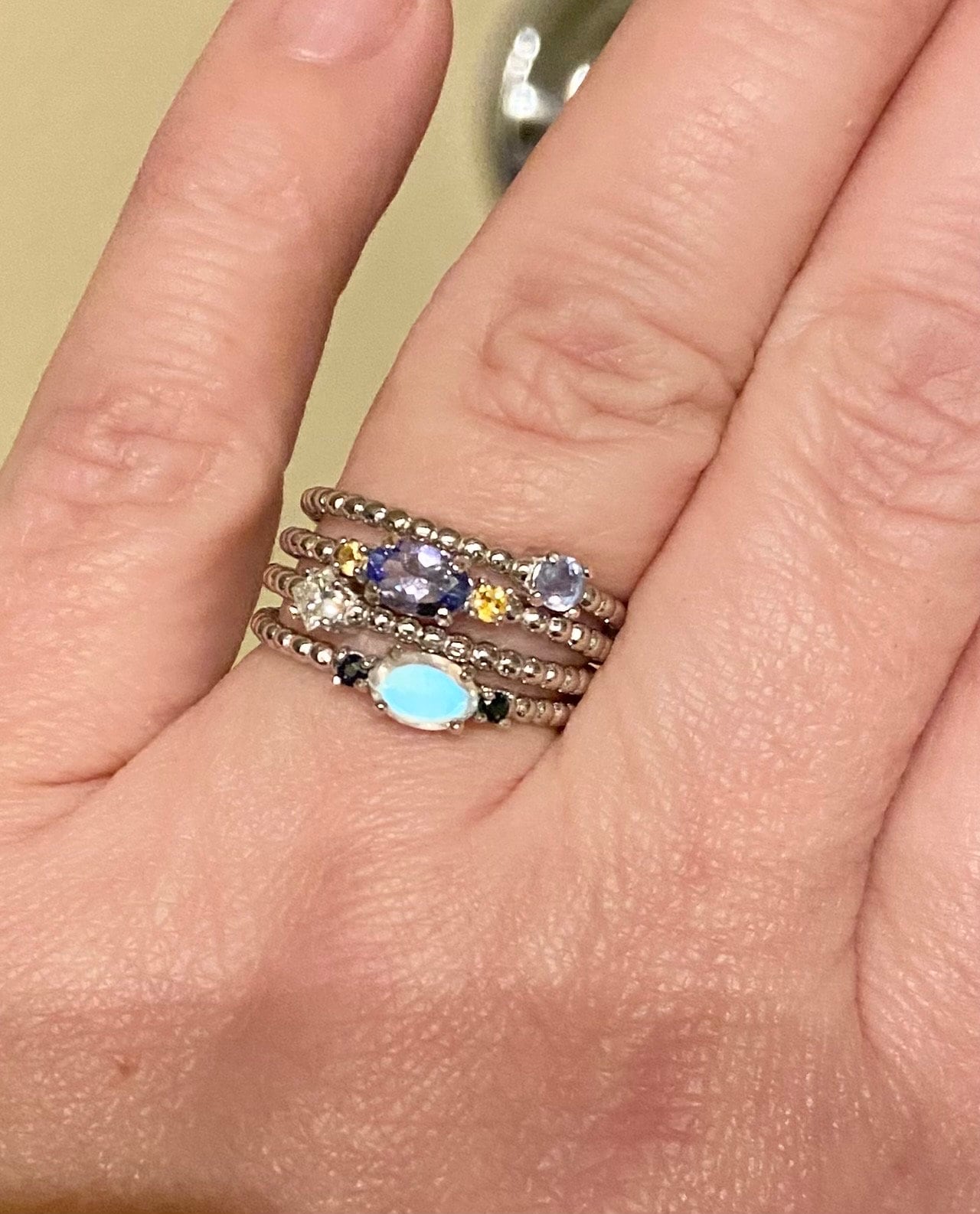 Stackable beaded band ring with a princess cut diamond and colorful gemstones.