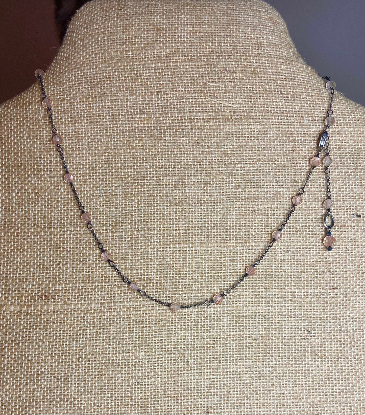 Oregon sunstone beaded sterling silver station necklace on burlap.