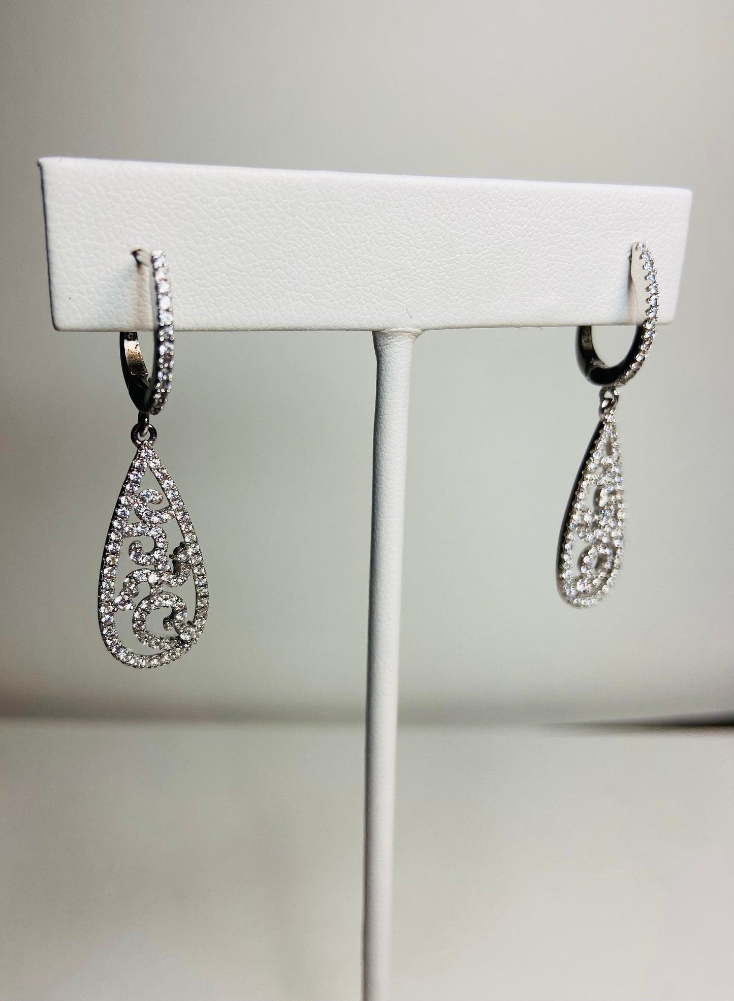 Sterling silver pave tear drop dangle earrings with lever back closure.
