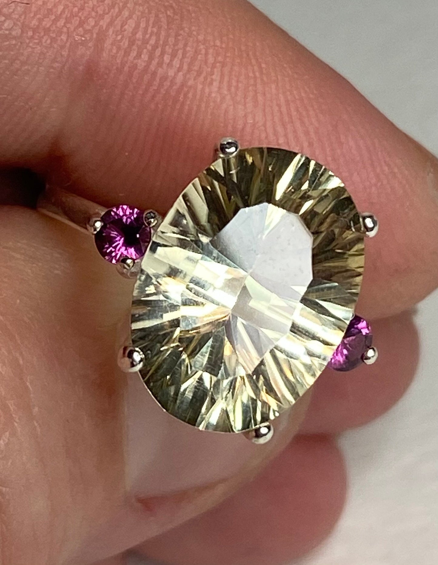 Sterling silver ring with a large oval Oregon sunstone and two small rhodolite garnets.