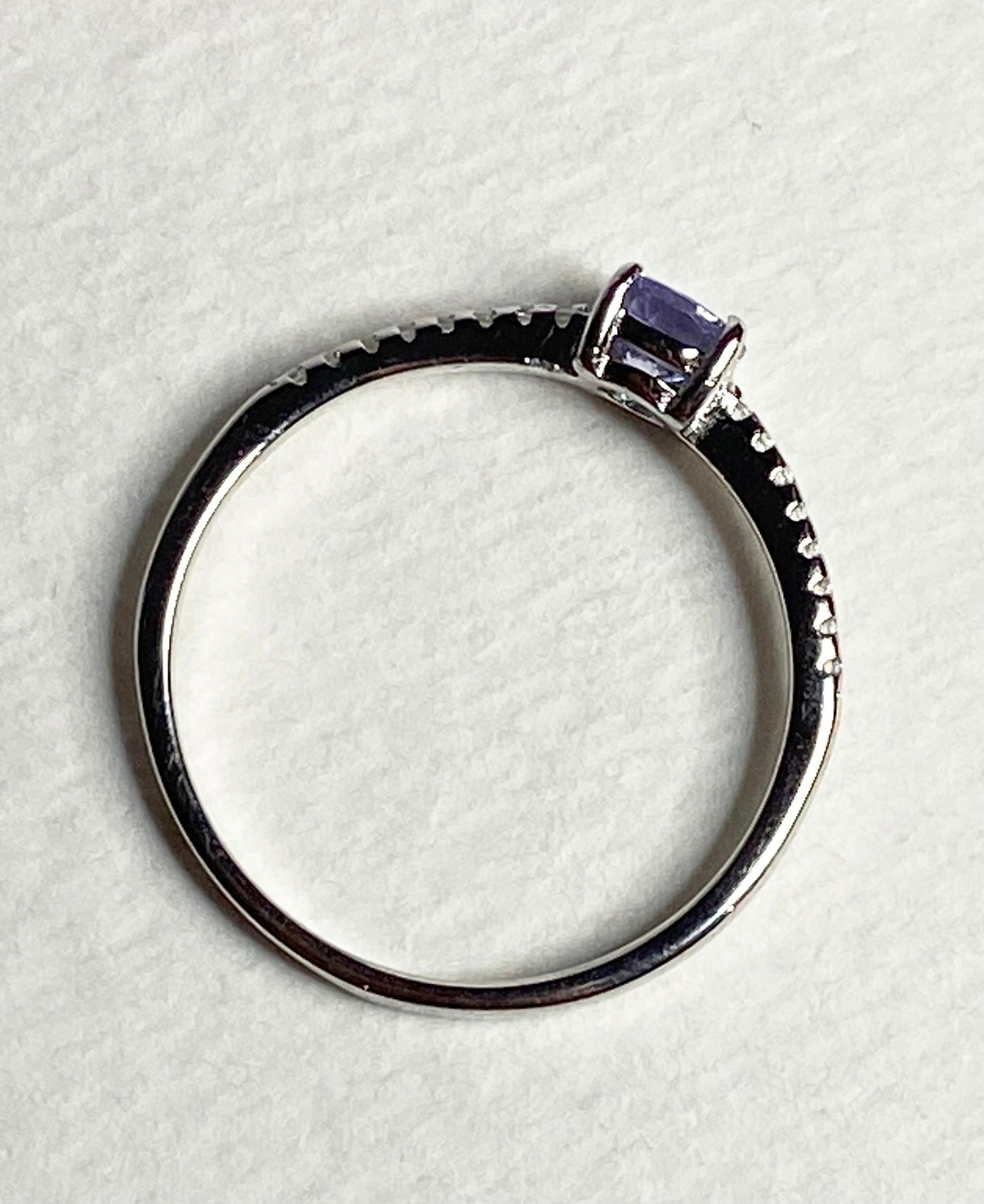 Sterling silver ring with a round tanzanite and small accent stones.