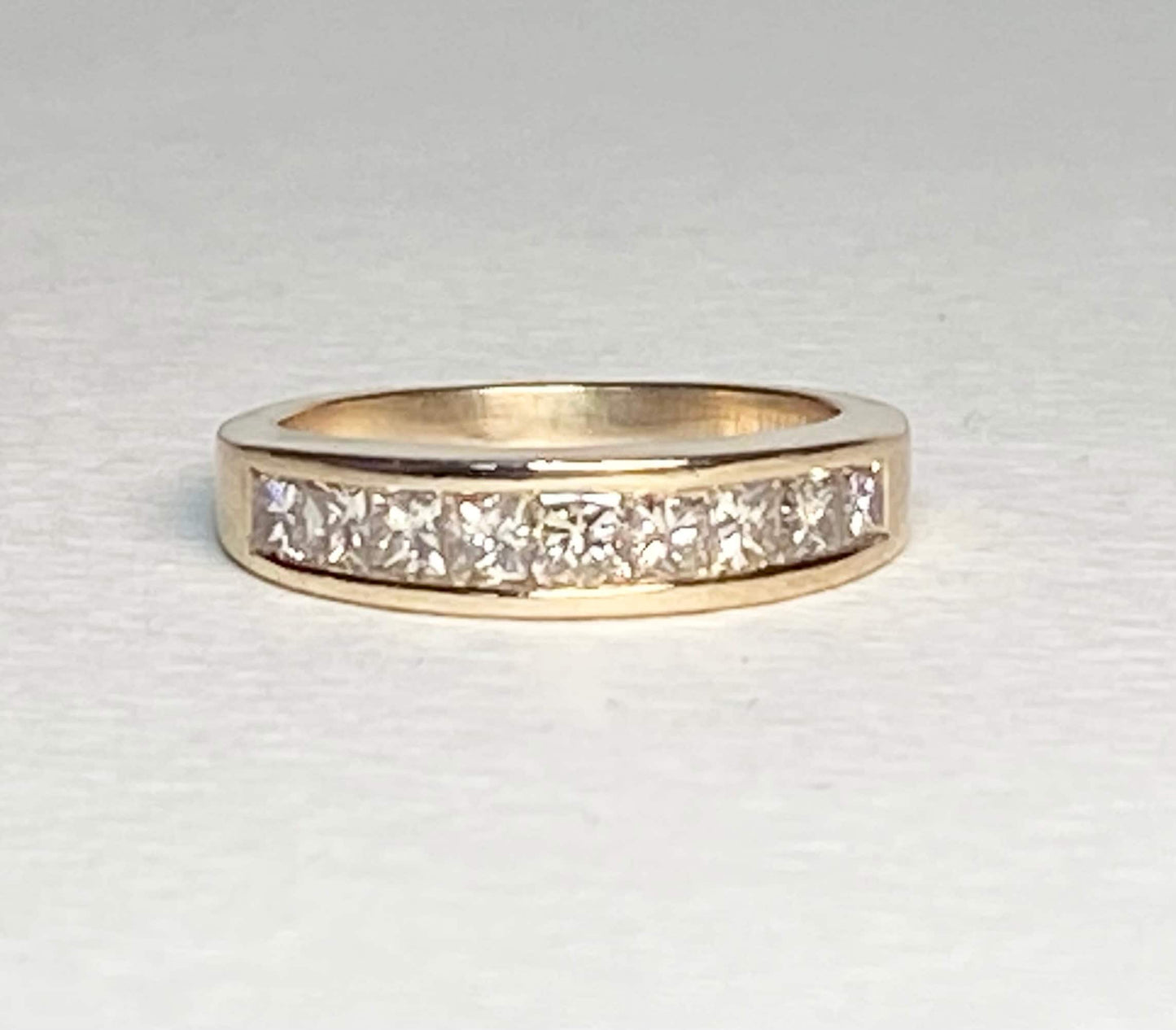 14k yellow gold anniversary band with princess cut diamonds.