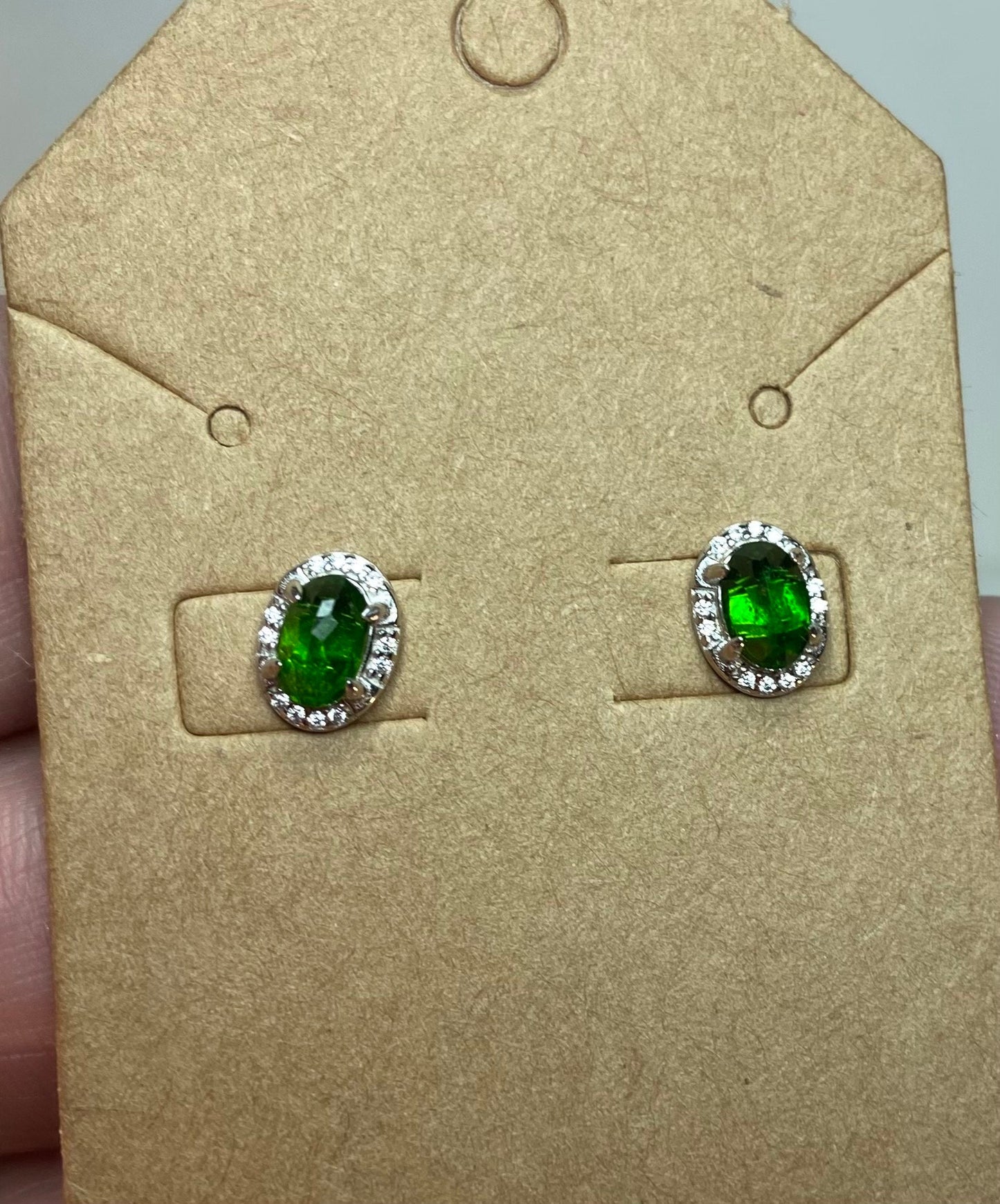 Sterling silver stud earrings with oval chrome diopside and diamond accents.