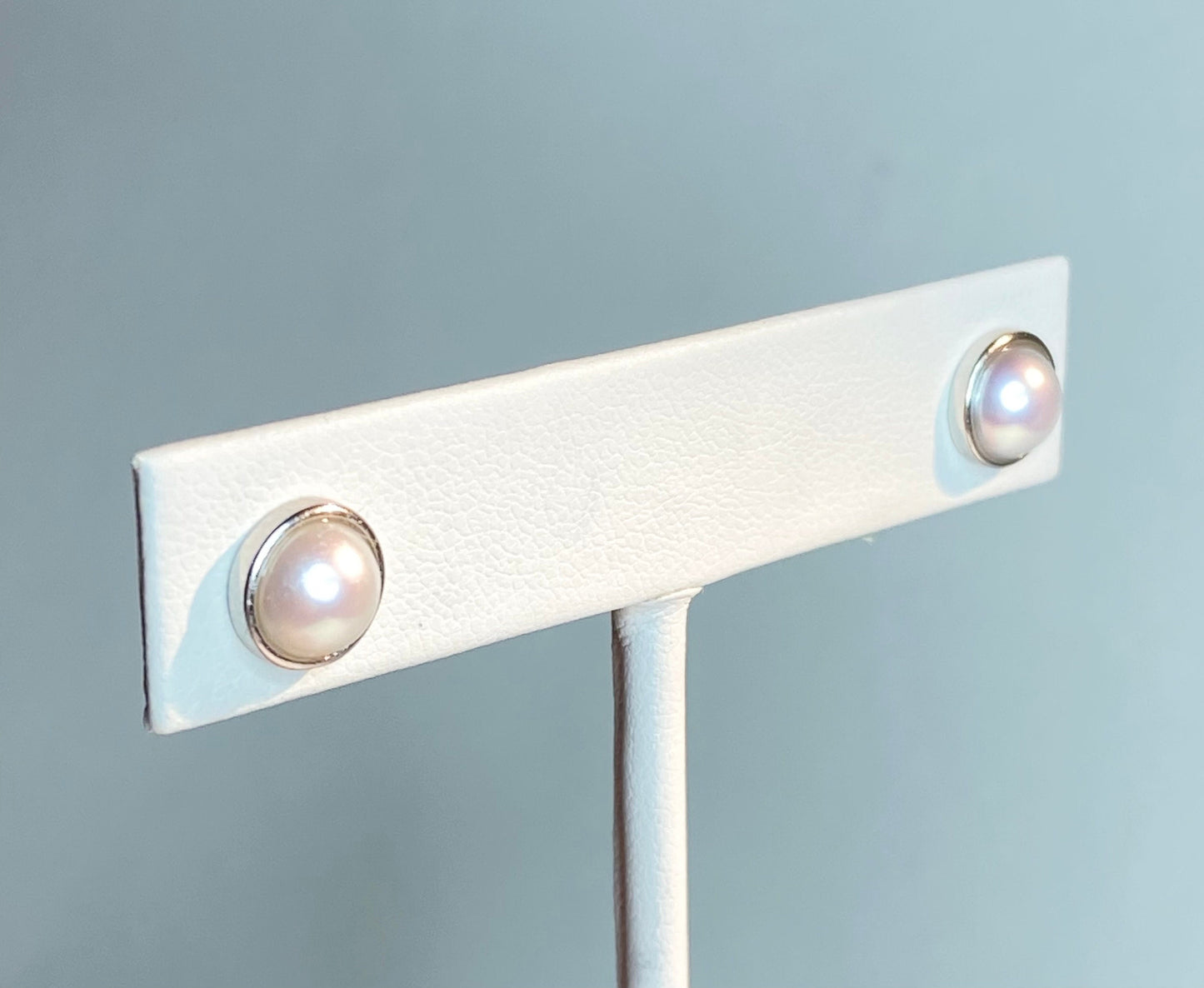 Genuine 6.5mm cultured pearl halves in sterling silver bezel stud earrings.