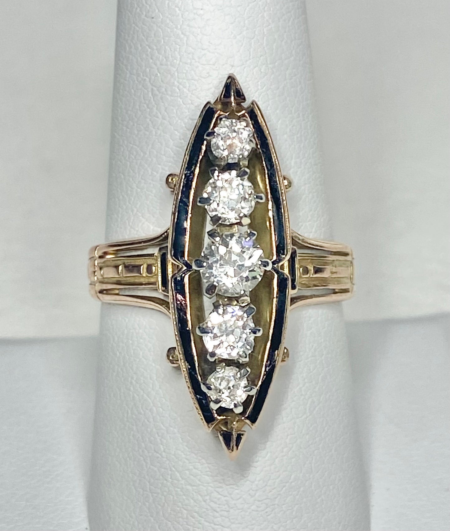 Antique Victorian navette ring with five old mine cut diamonds and black enamel on 14k gold.