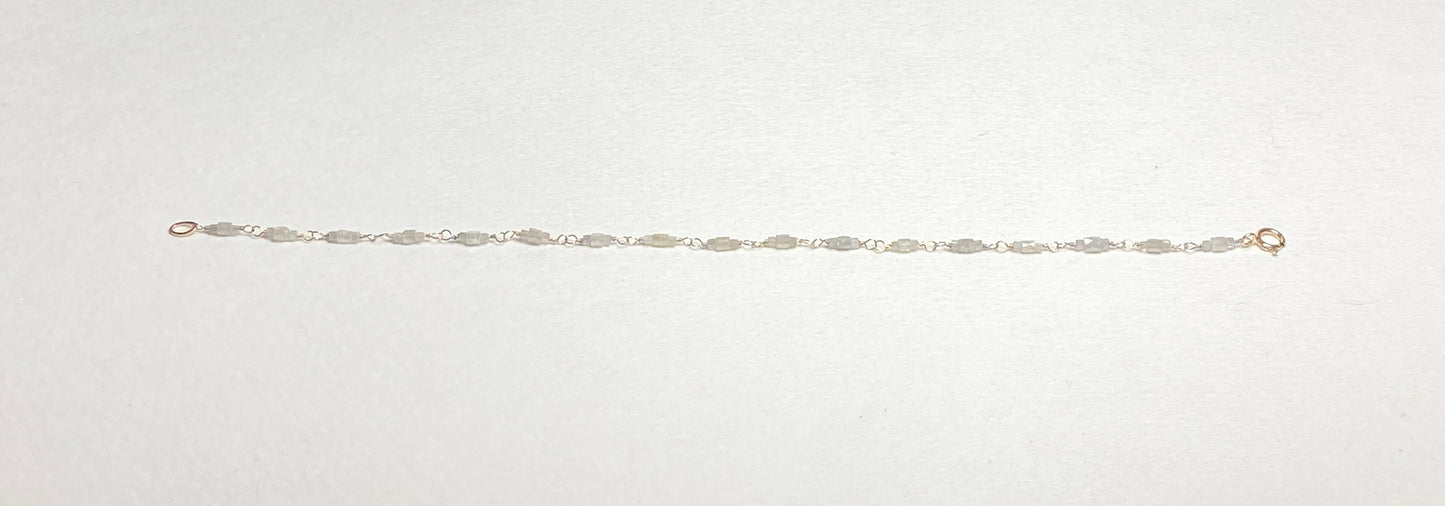 A delicate bracelet with faceted diamond beads and a gold clasp.