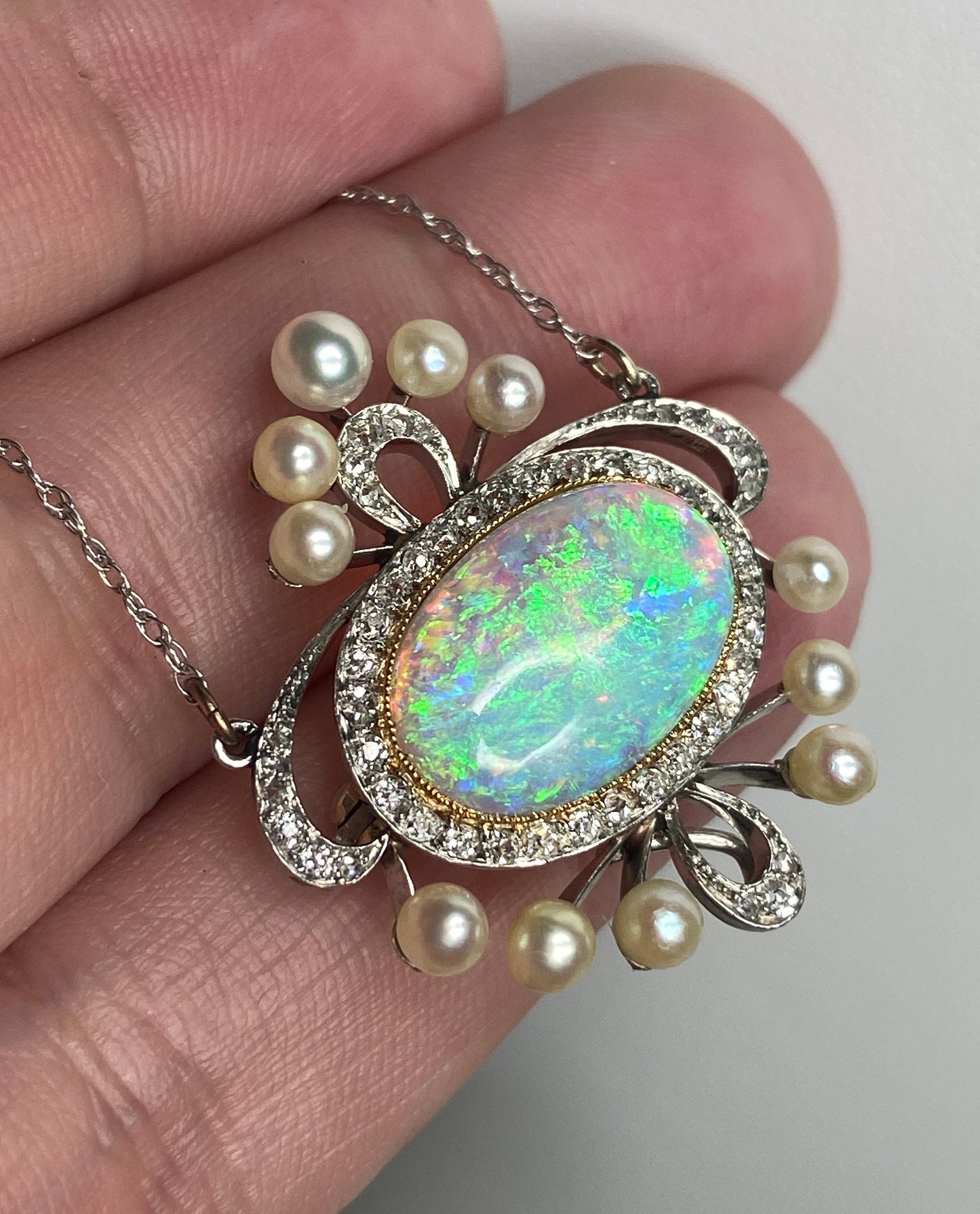Edwardian platinum, 18k, and 14k gold necklace with opal, pearls, and diamonds.