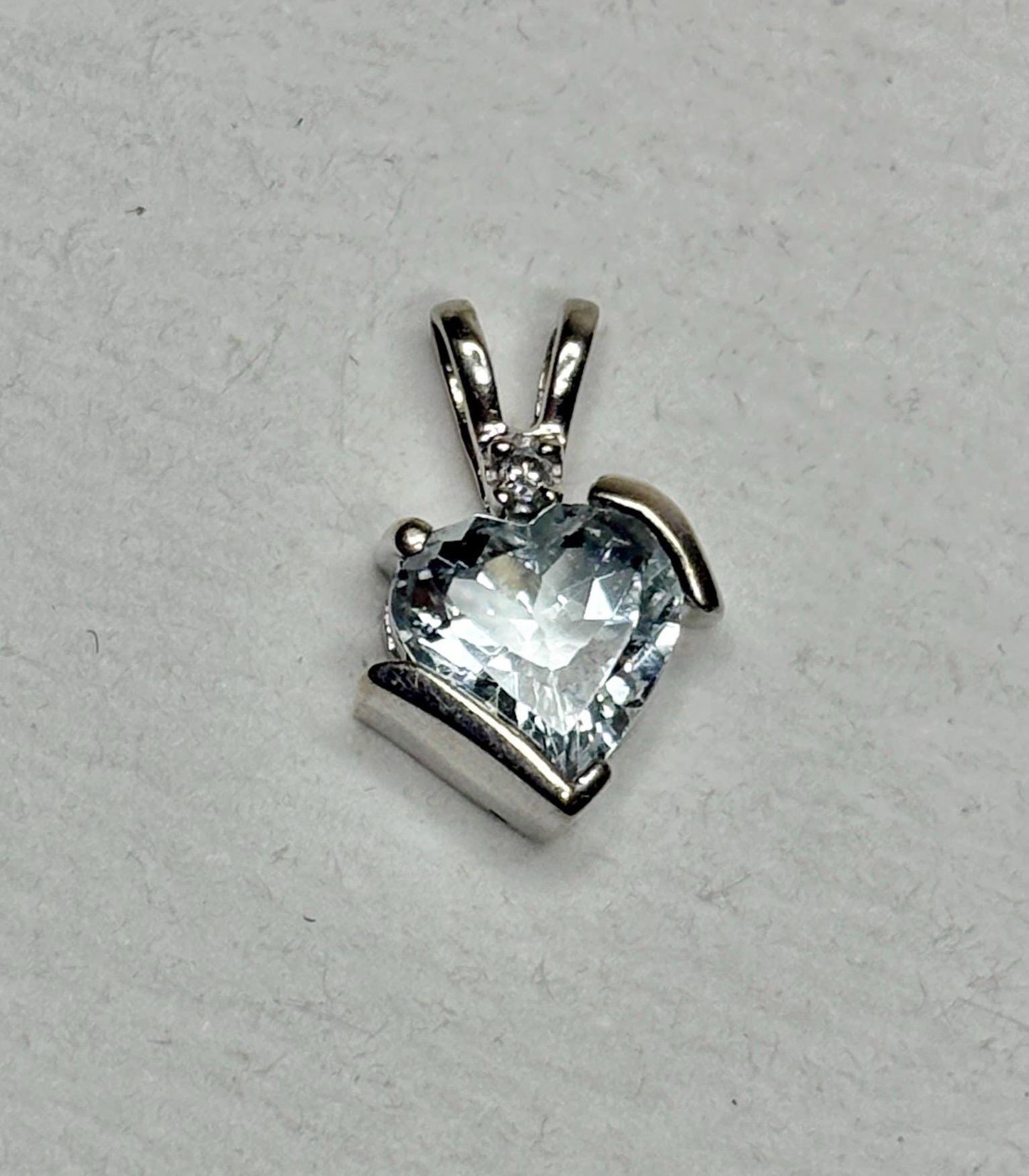 Heart-shaped aquamarine and diamond pendant in 10k white gold.