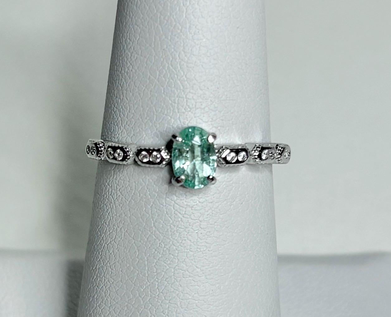 Sterling silver ring with an oval mint green tourmaline and crystal accents.