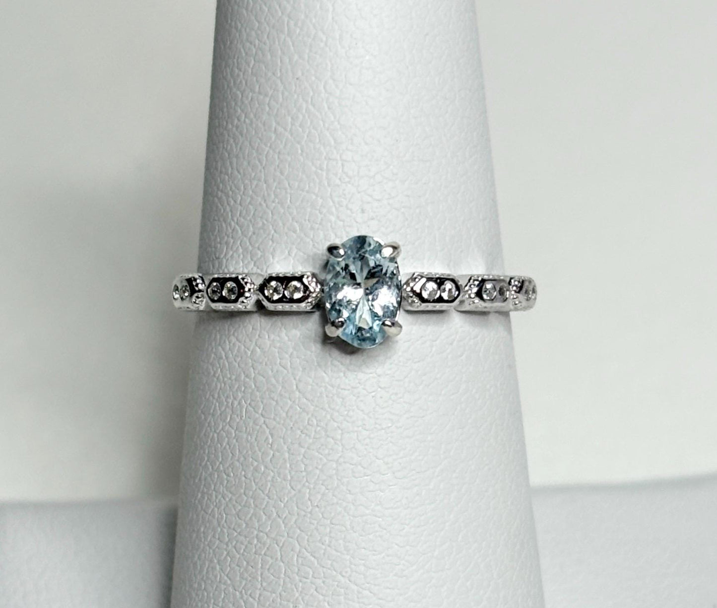 Sterling silver ring with an oval light blue tourmaline and crystal accents.