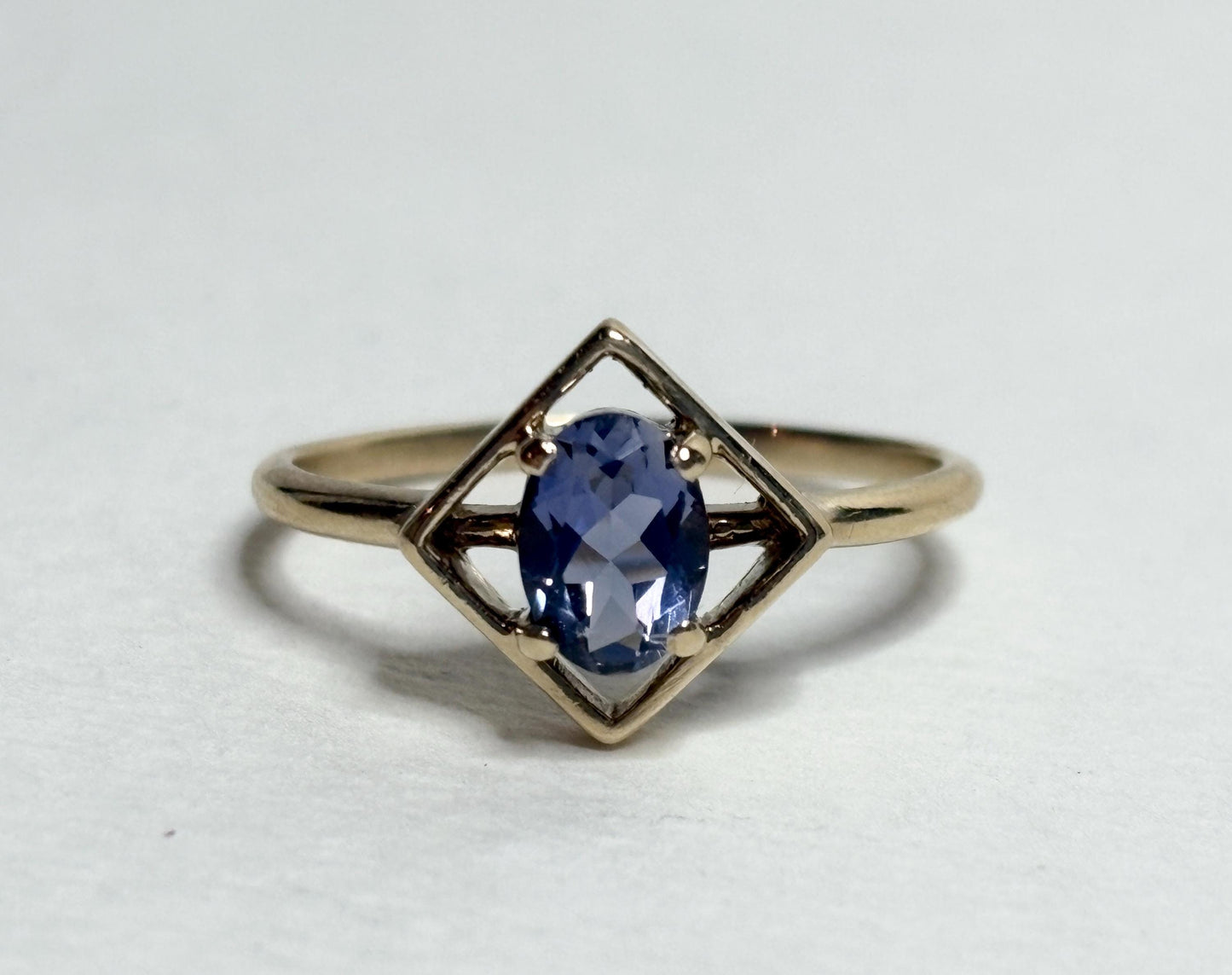 Geometric 10k gold ring with an oval iolite solitaire.