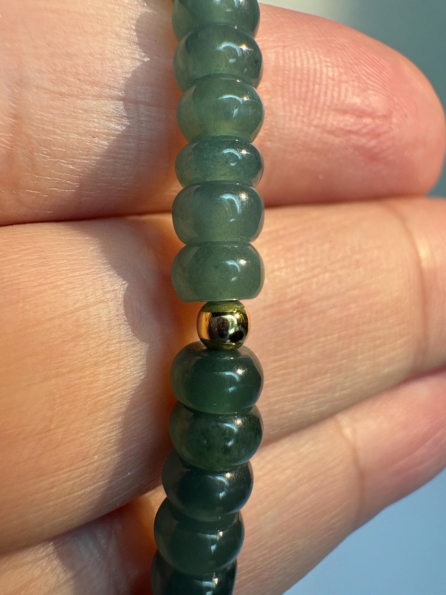 Guatemalan Type A jadeite jade stretch bracelet with gold beads.