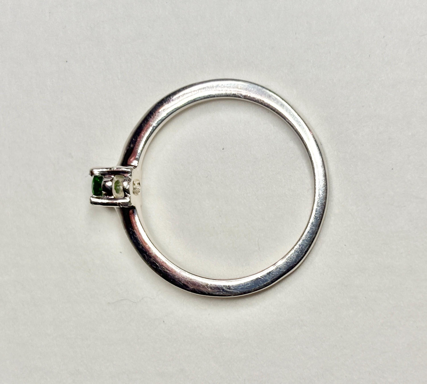 Sterling silver ring with a small oval chrome diopside stone.