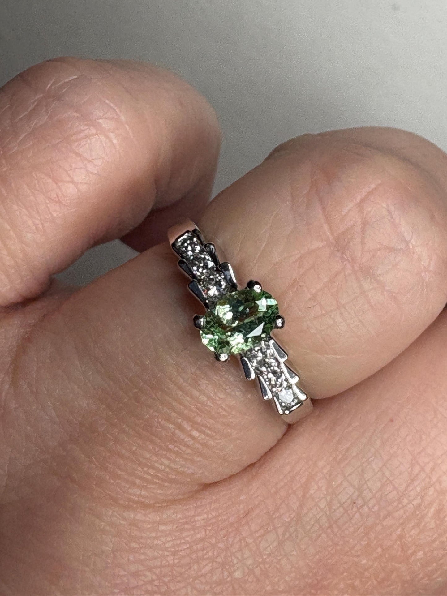 A green tourmaline and diamond ring in 14k white gold.