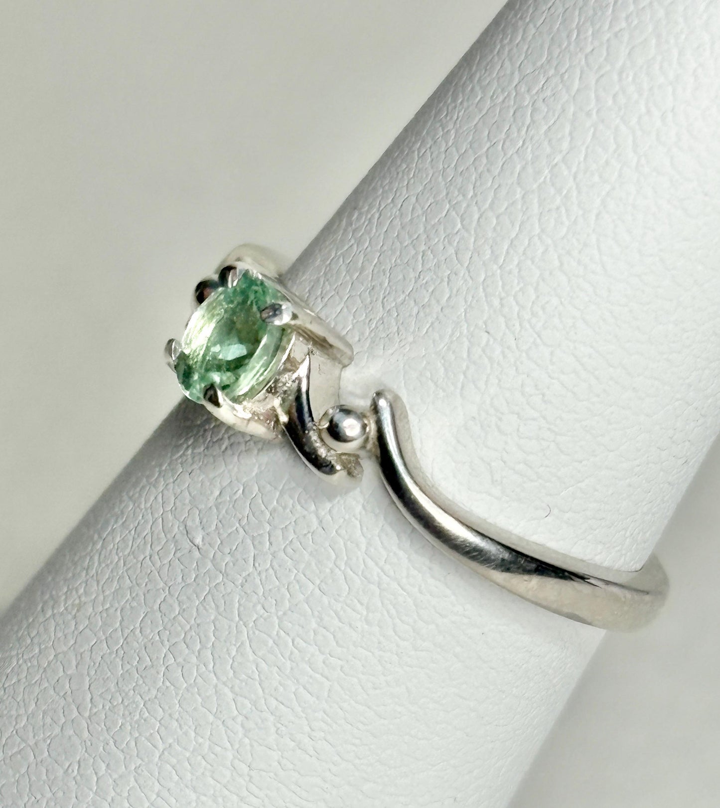 Sterling silver ring with a light green oval tourmaline gemstone.