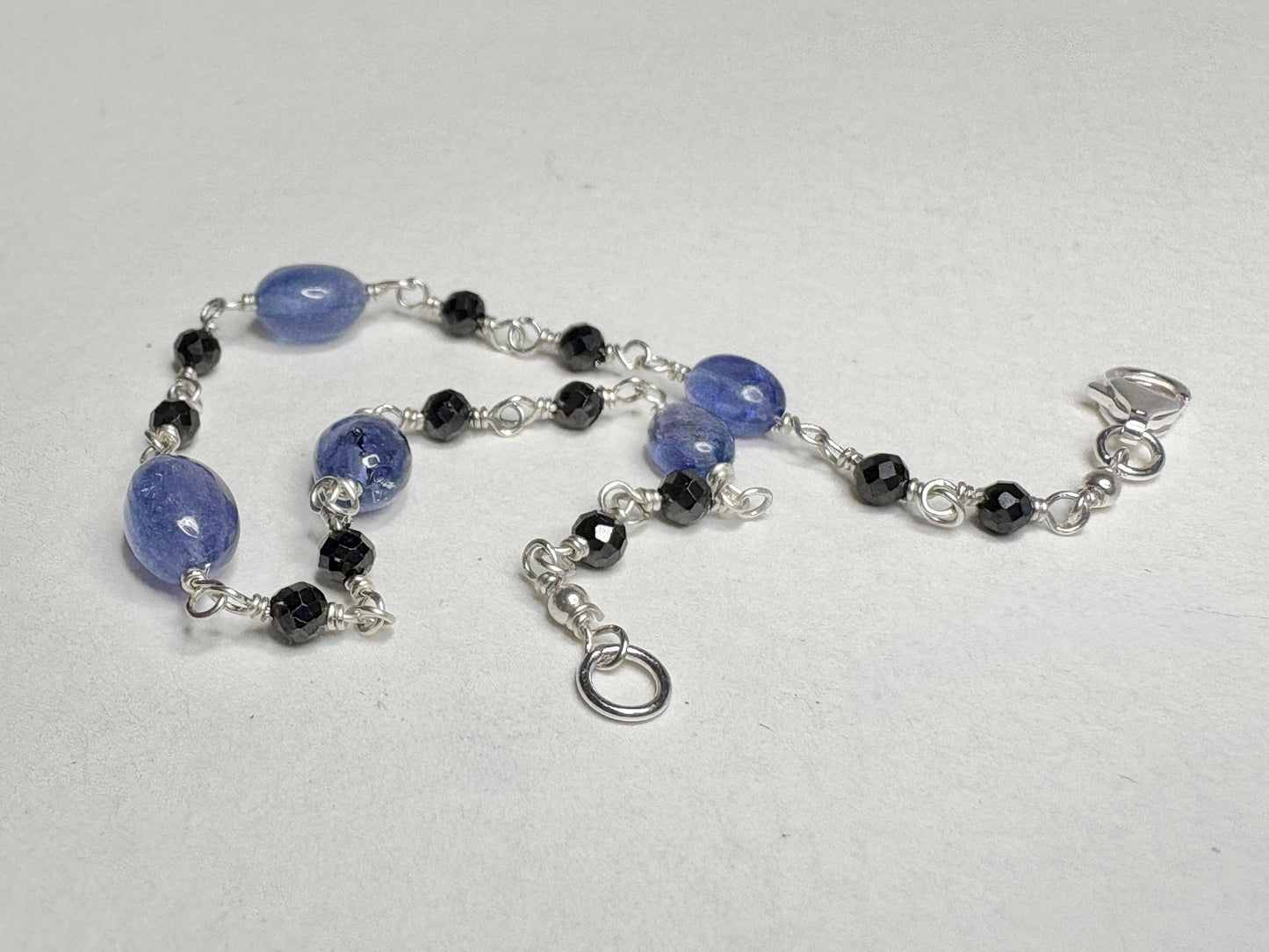 Sterling silver bracelet with black diamond and tanzanite beads.