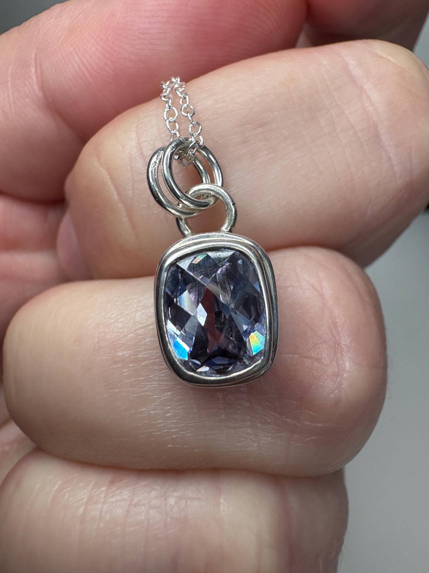 Sterling silver pendant necklace with a lavender checkerboard faceted CZ.