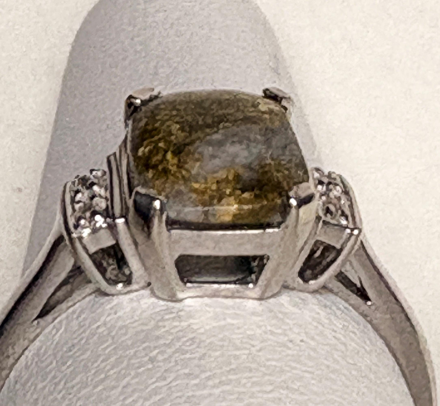 10k white gold ring with a cushion-shaped gold in quartz stone and diamonds.