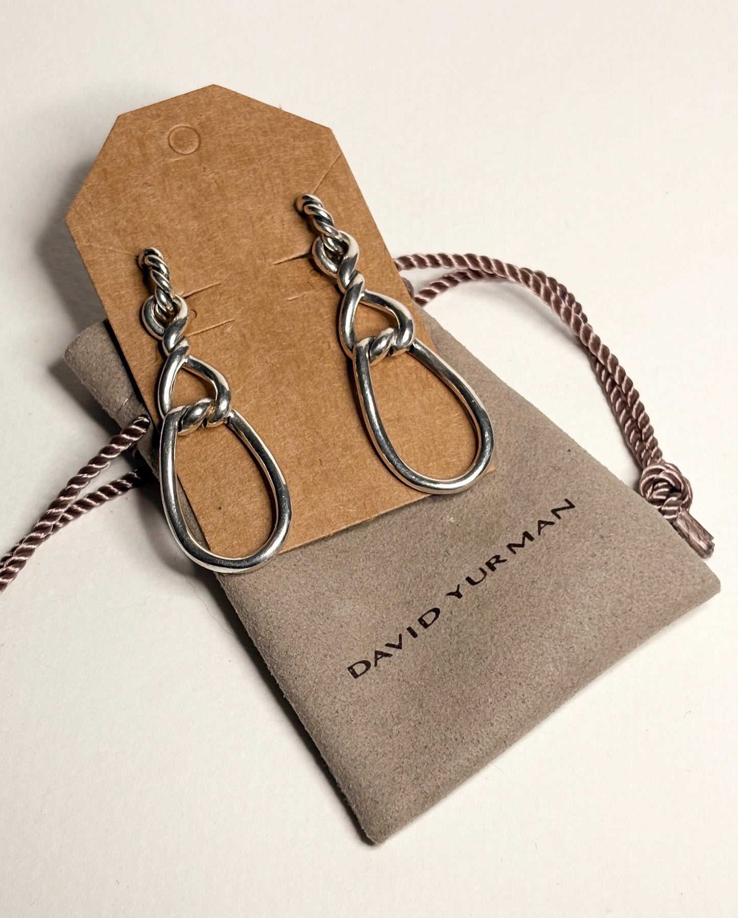 Sterling silver dangle earrings with a twisted rope design and gold posts.