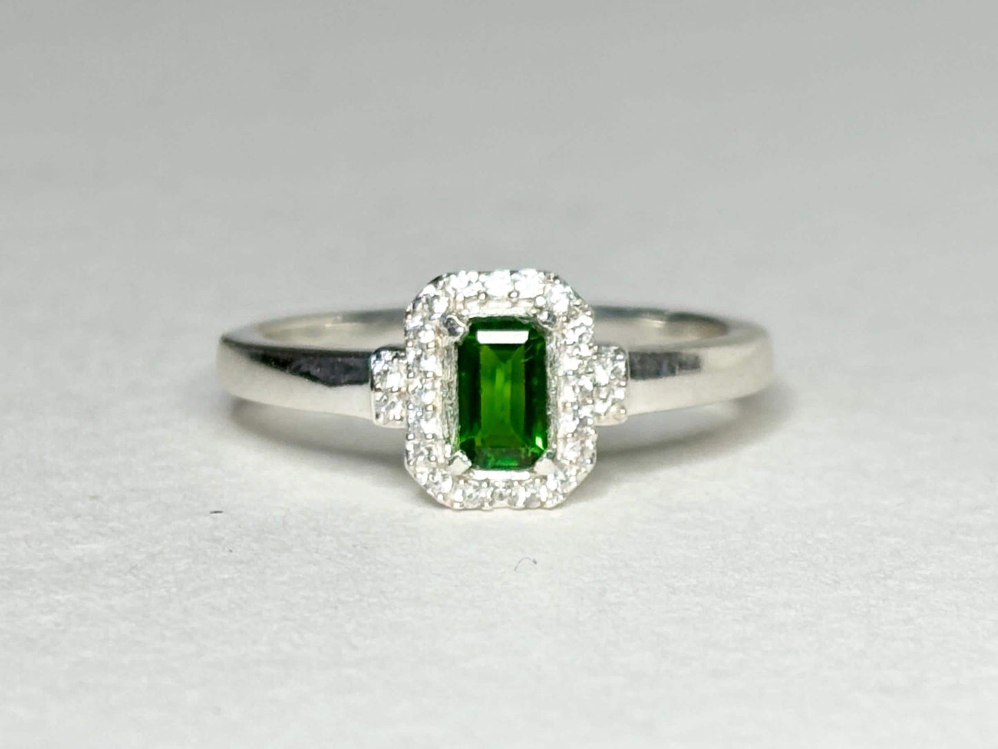 Sterling silver ring with emerald-cut chrome diopside and zircon halo.