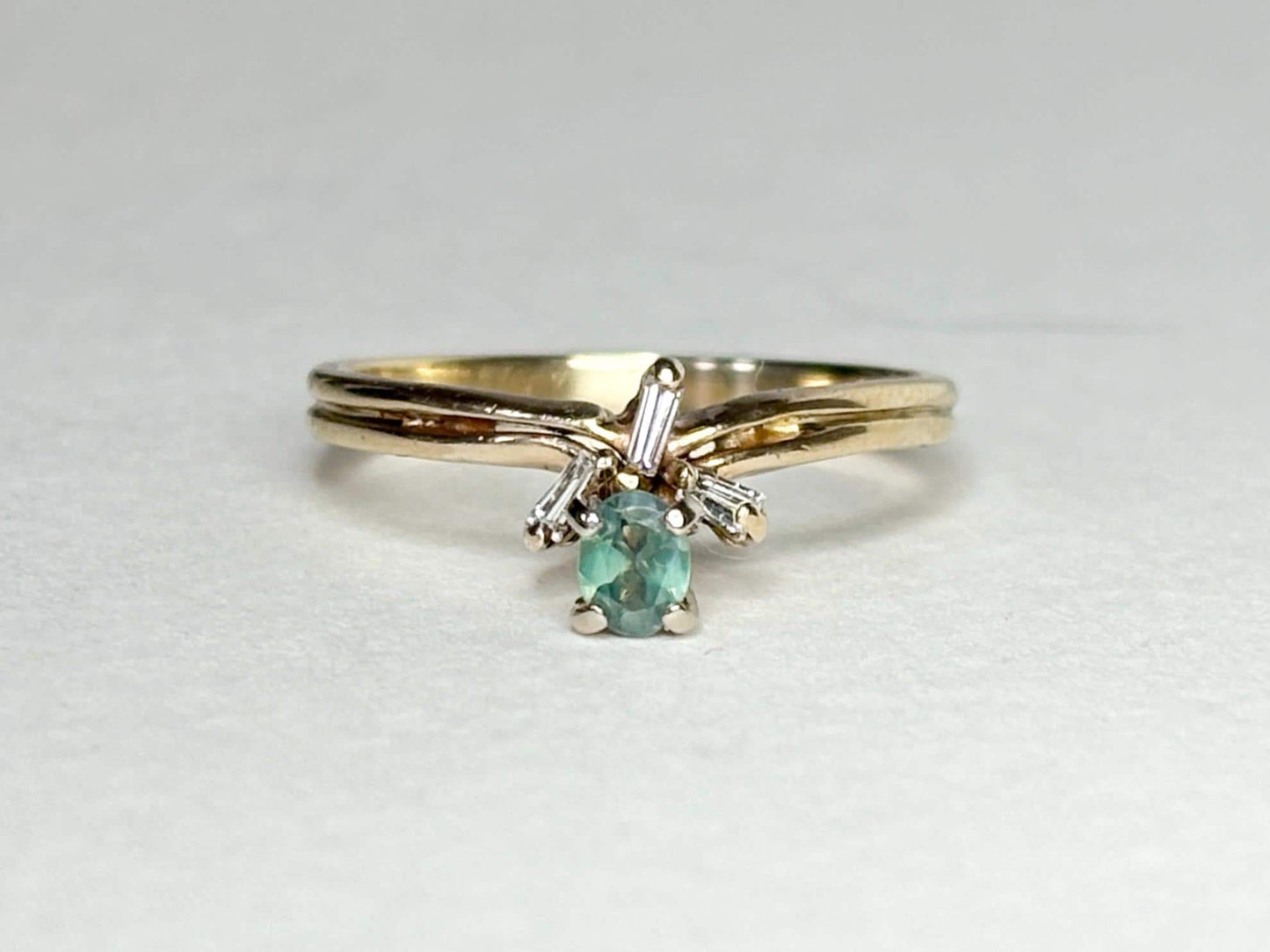 Oval alexandrite and baguette diamond ring in 14k gold.