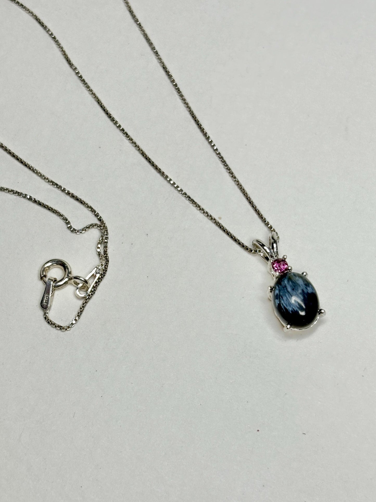 Sterling silver necklace with African blue pietersite and rhodolite garnet pendant.