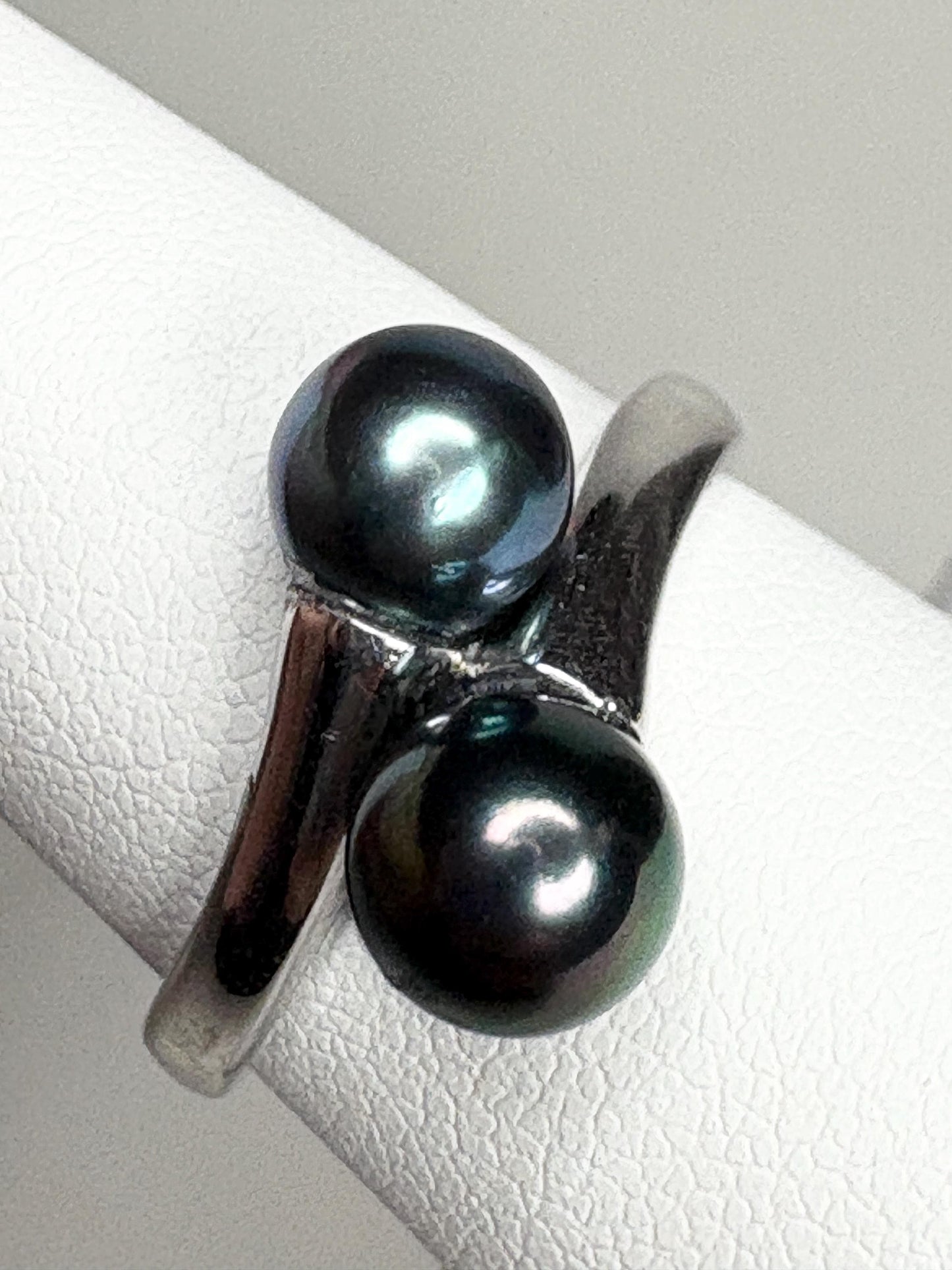 Sterling silver bypass ring with two black Akoya cultured pearls.