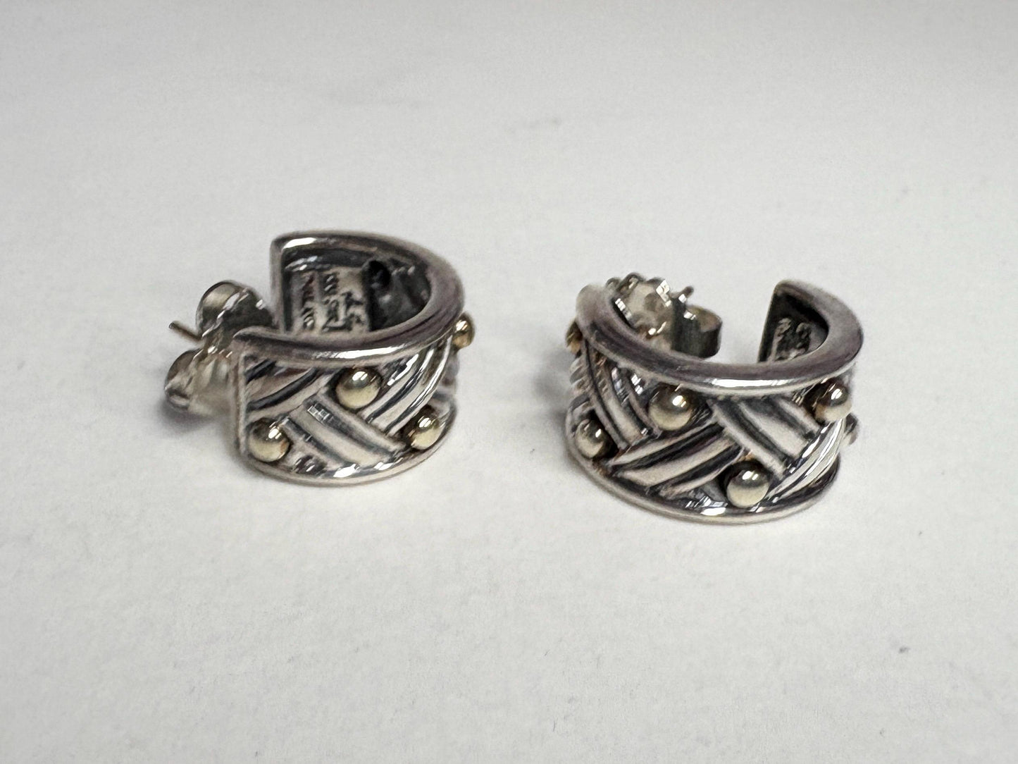 Ann King wide woven hoop earrings in 18k gold and sterling silver.