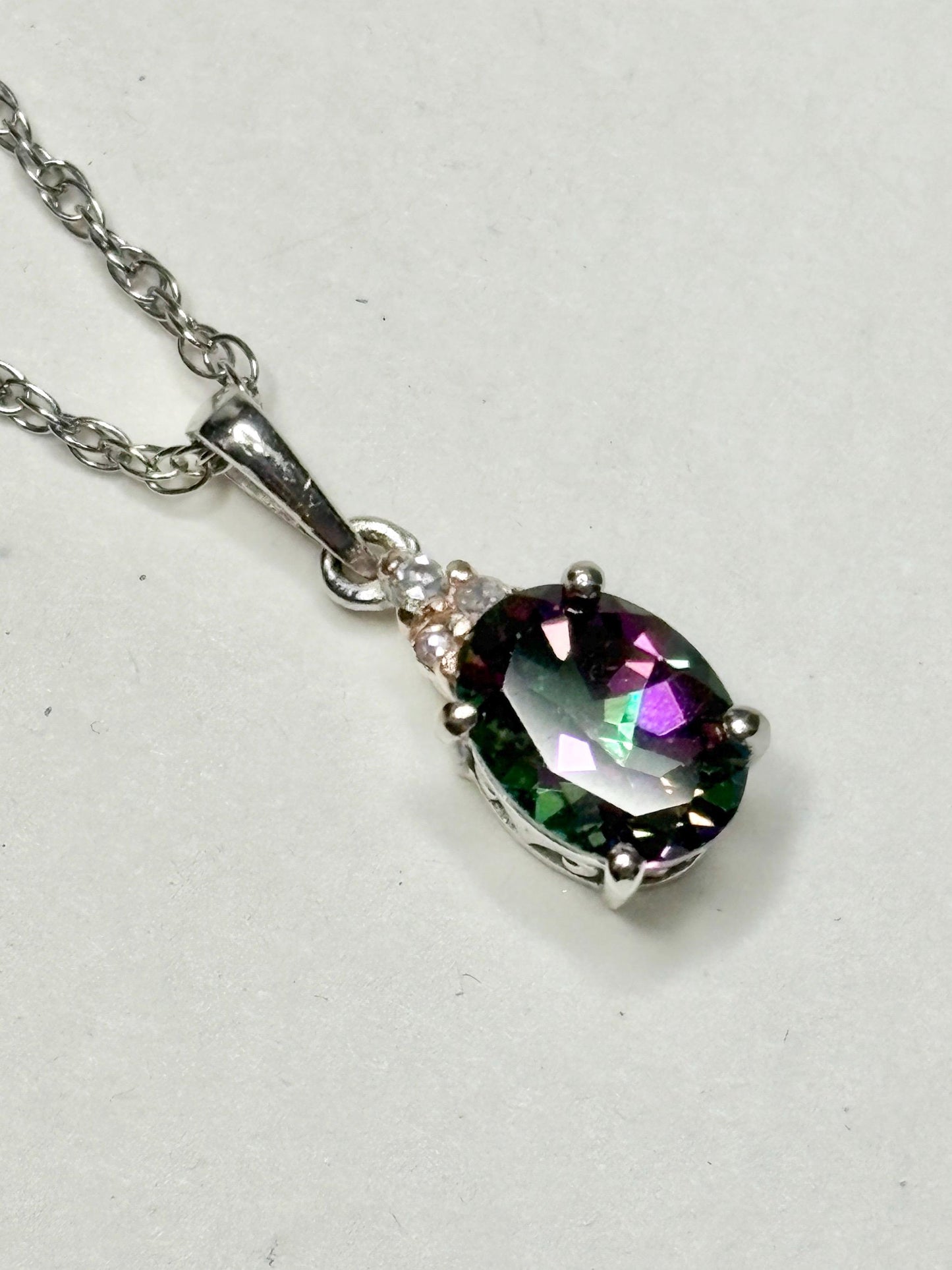 Sterling silver pendant necklace with oval mystic topaz and lab-grown diamonds.