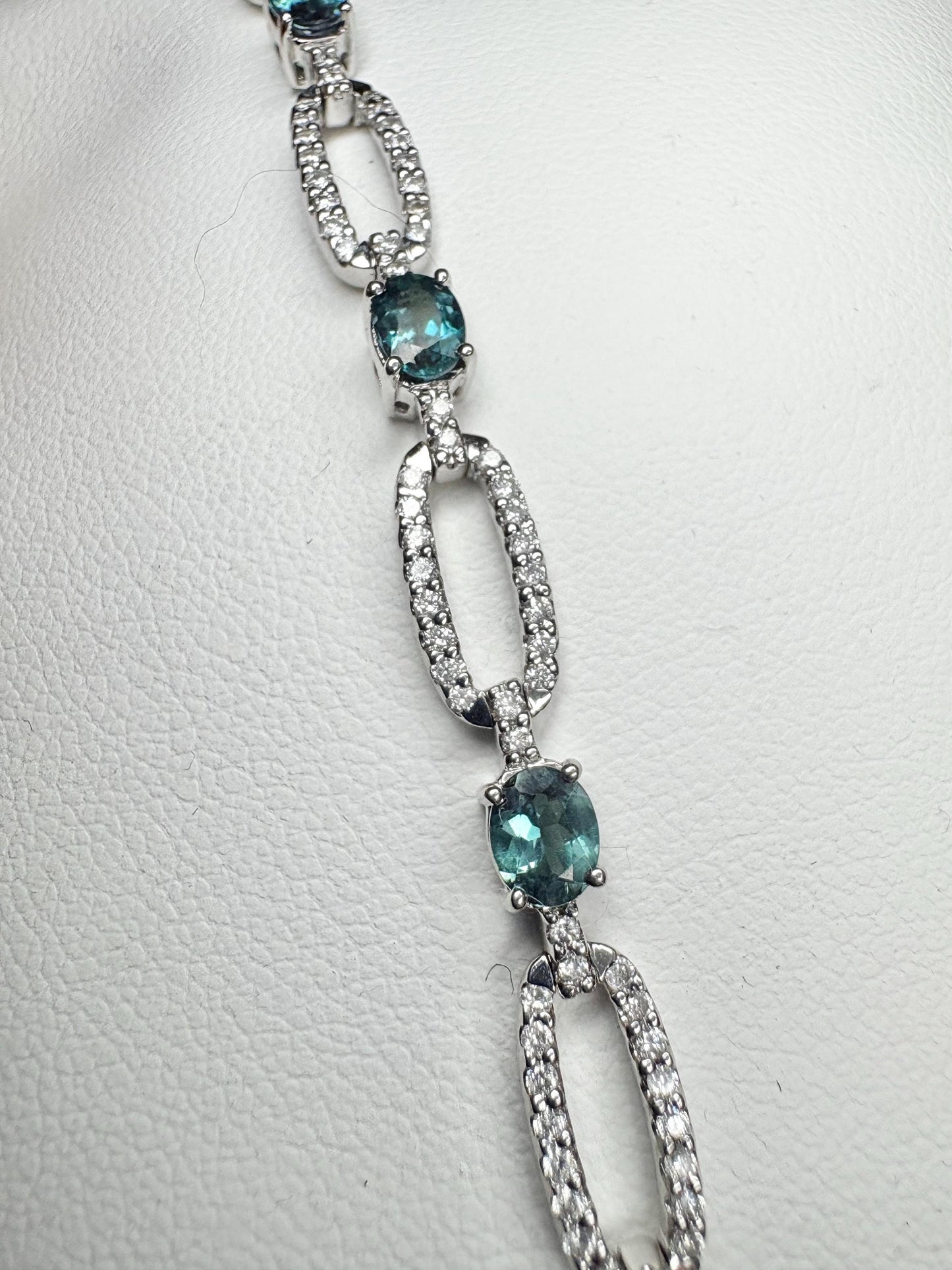 A white gold bracelet with oval alexandrite stones and diamonds.