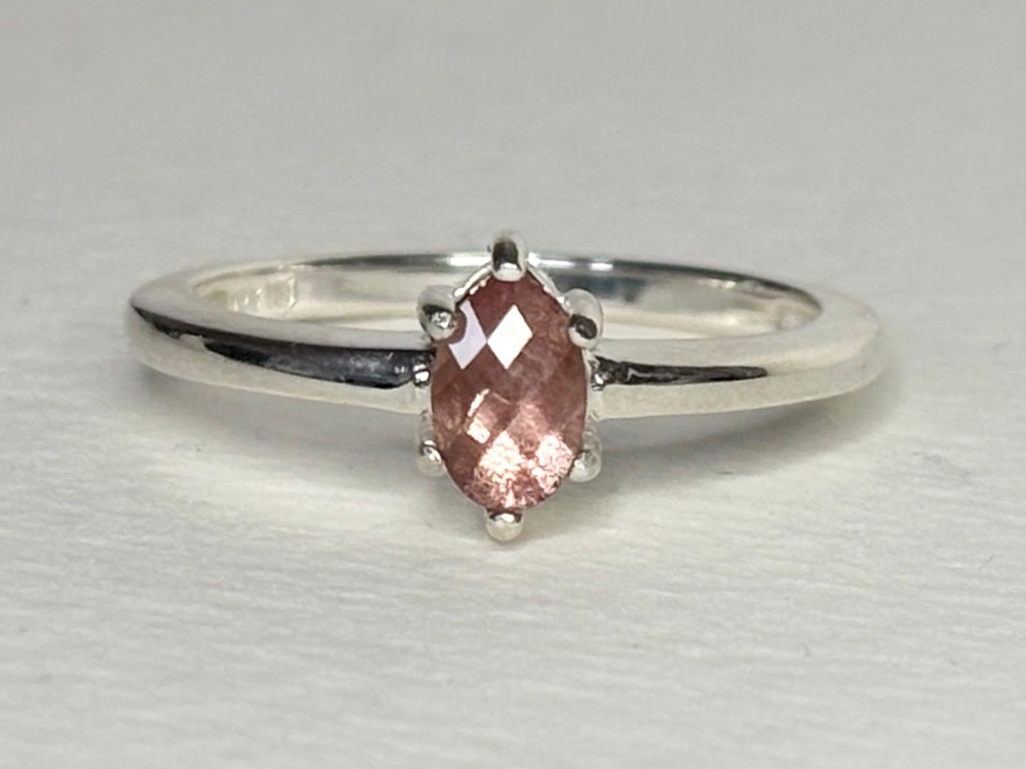 Sterling silver ring with a pear-shaped peach Oregon sunstone.