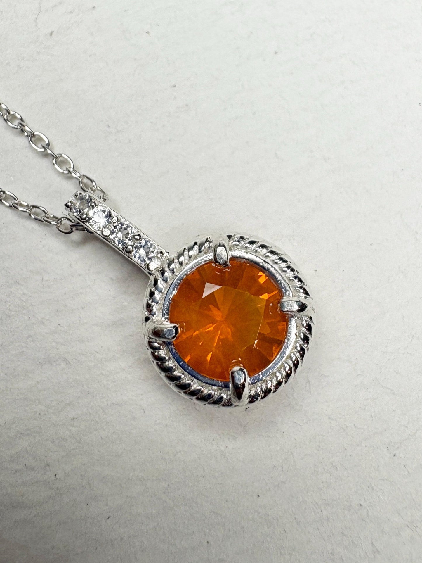 Sterling silver pendant necklace with an Oregon fire opal and white topaz accents.