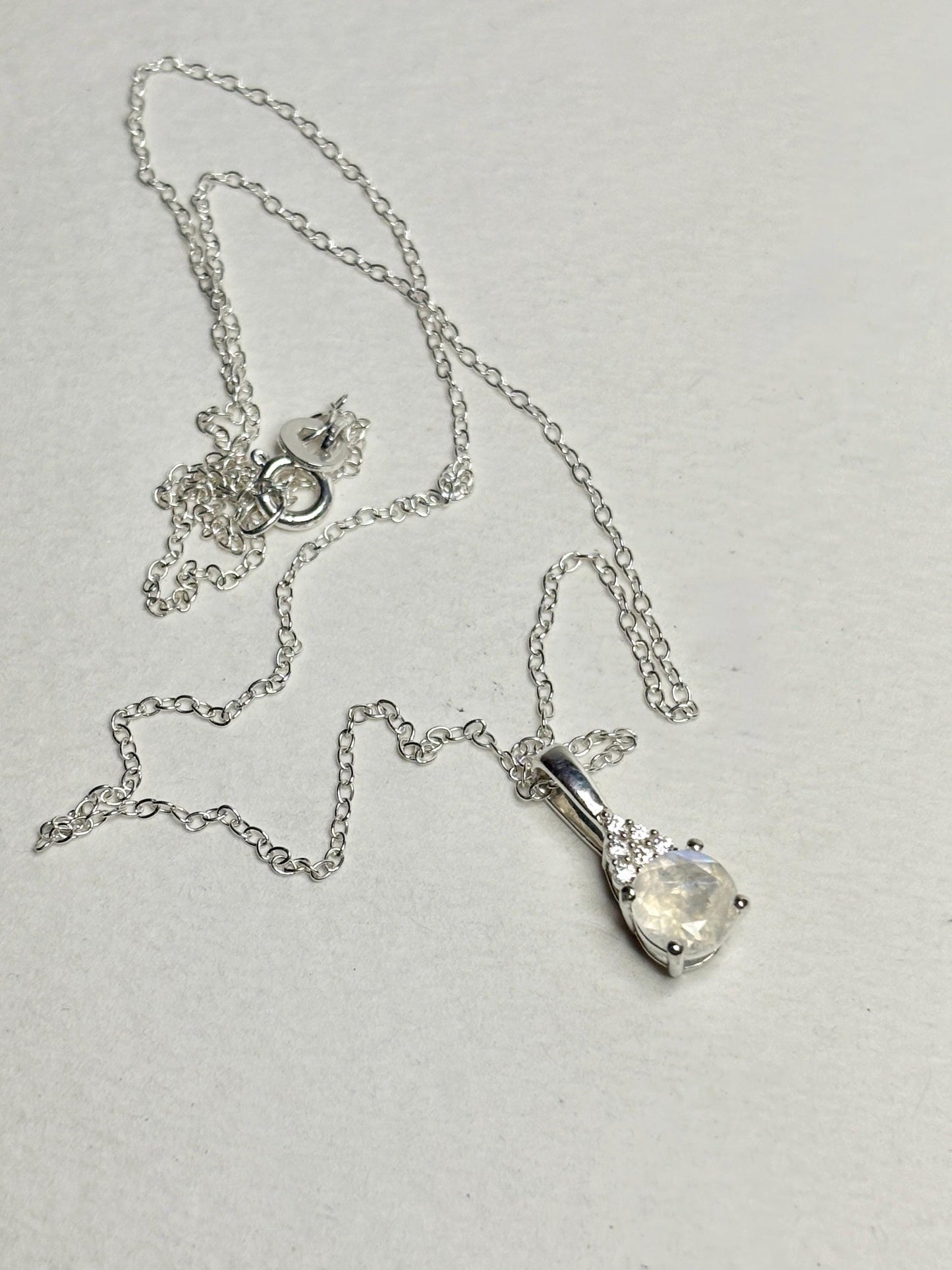 Sterling silver necklace with rainbow moonstone and zircon pendant.
