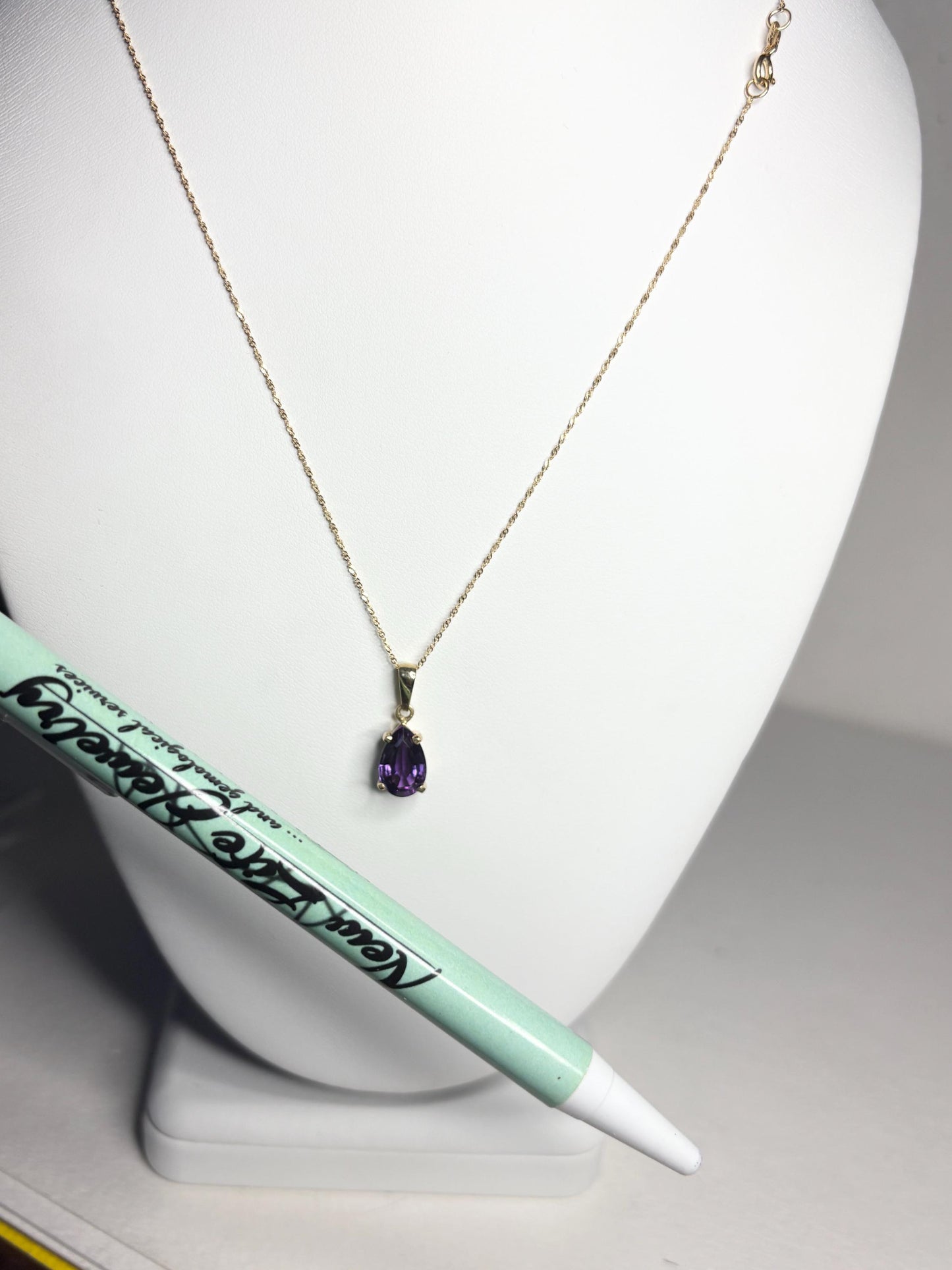 14k gold necklace with a pear-shaped amethyst pendant.