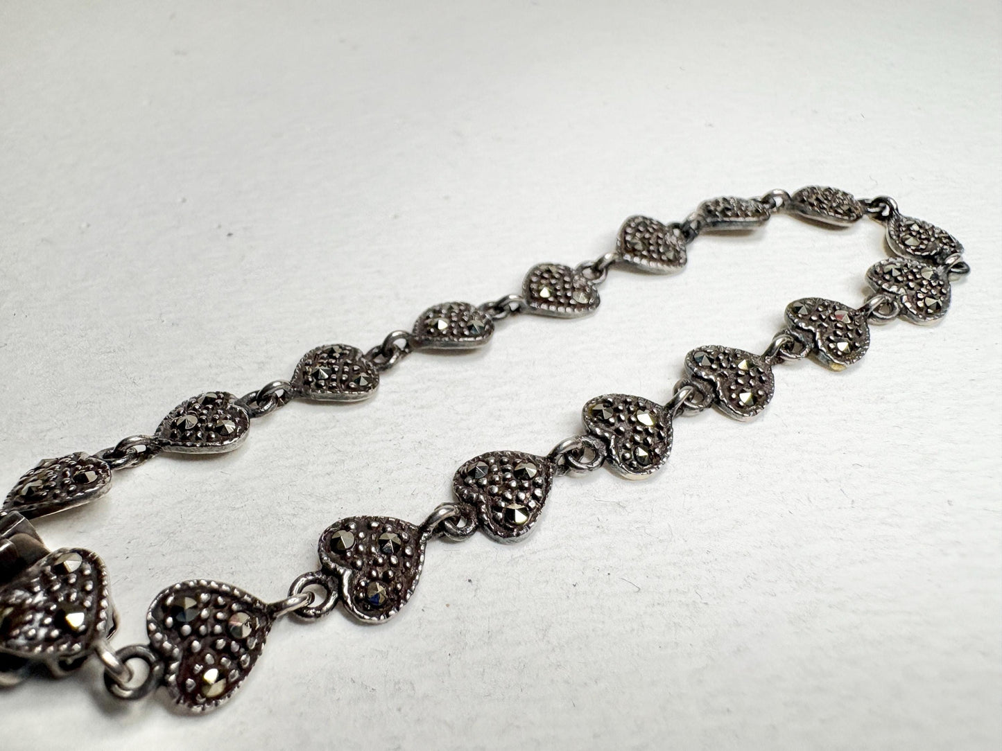 Sterling silver bracelet with oxidized marcasite-studded heart links.