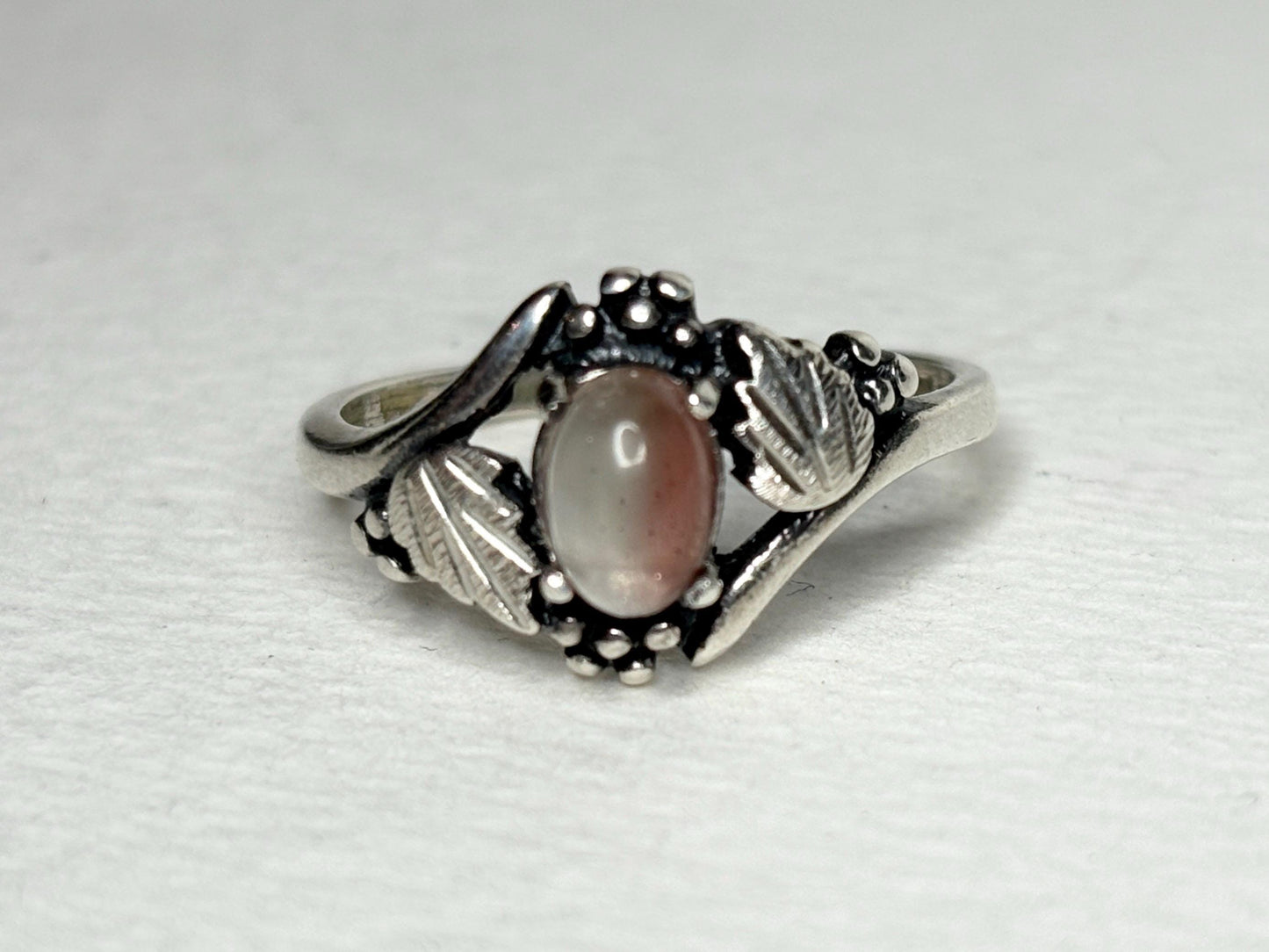 Vintage sterling silver ring with a bicolor Oregon sunstone cabochon.