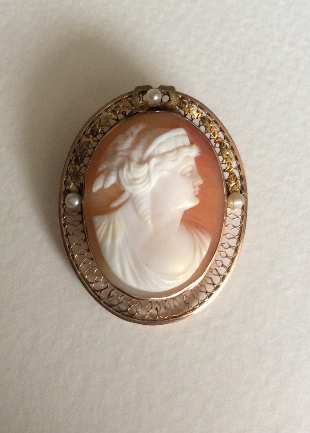 Victorian 10k gold cameo brooch pendant with shell carving and seed pearls.