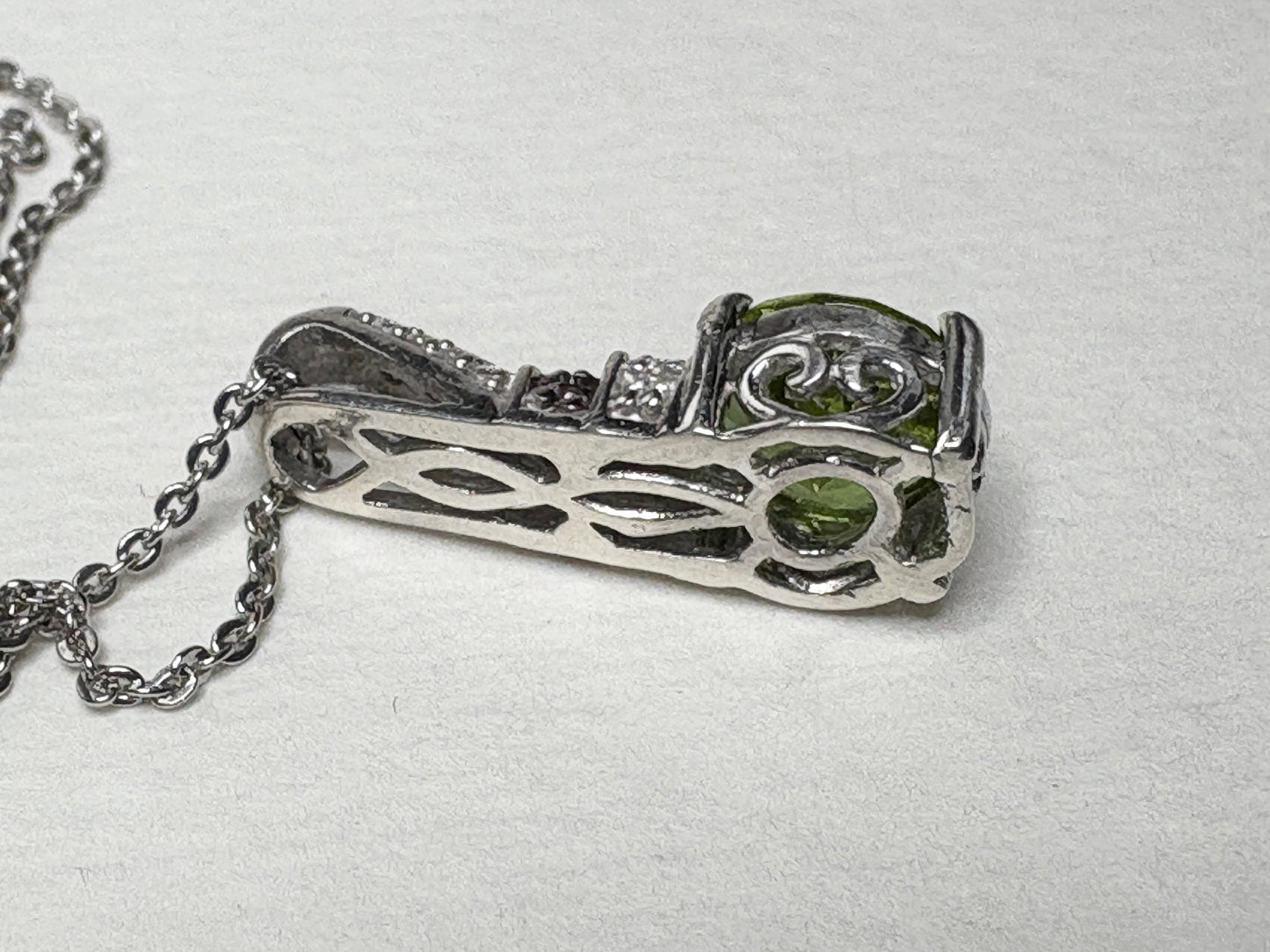 Sterling silver pendant necklace with color-changing glass, moissanite, and multi-color sapphires.