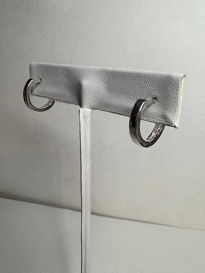 Sterling silver huggie hoop earrings with princess-cut multi-color sapphires.