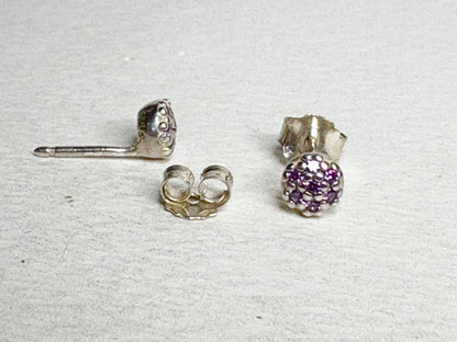 Sterling silver stud earrings with pave-set violet purple cubic zirconia stones.