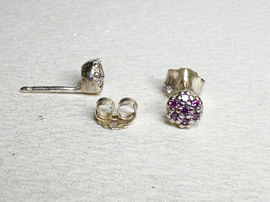 Sterling silver stud earrings with pave-set violet purple cubic zirconia stones.