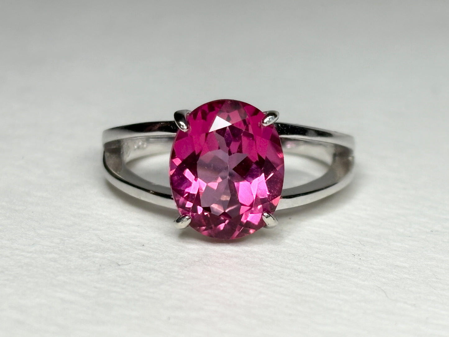 Sterling silver ring with a large oval pink topaz and a split shank.