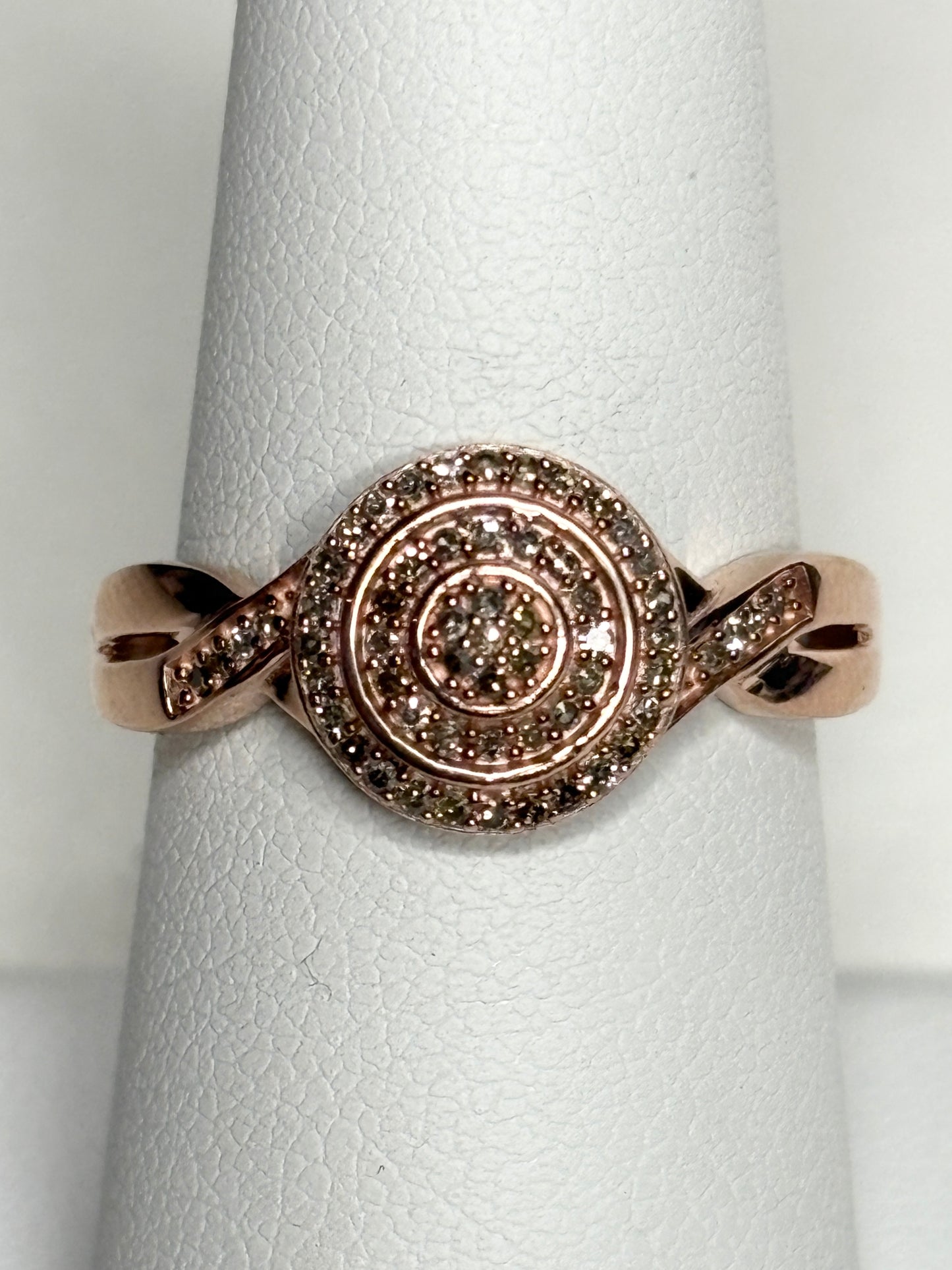 Rose gold ring with champagne and brown diamonds in a circular pave setting.