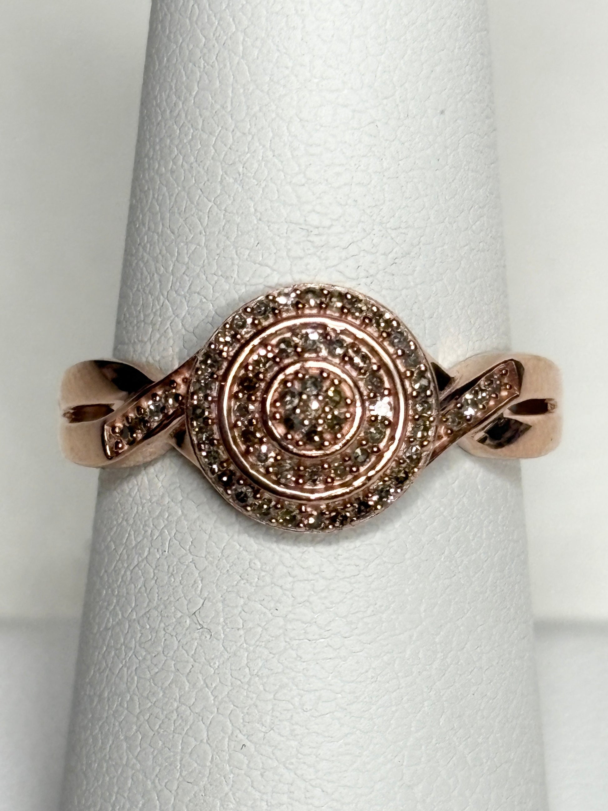 Rose gold ring with champagne and brown diamonds in a circular pave setting.