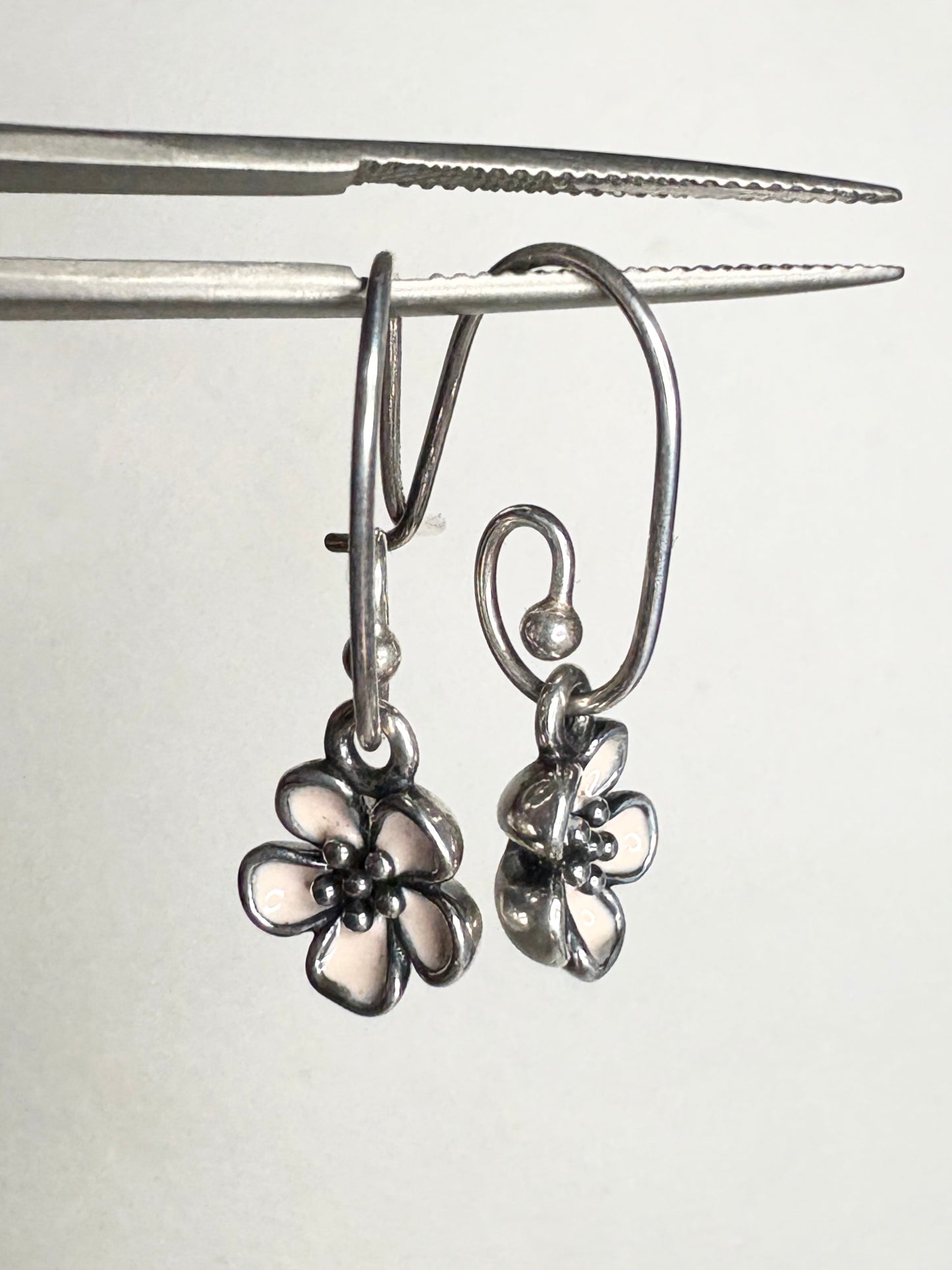 Pandora sterling silver dangle earrings with pink enamel cherry blossom charms.